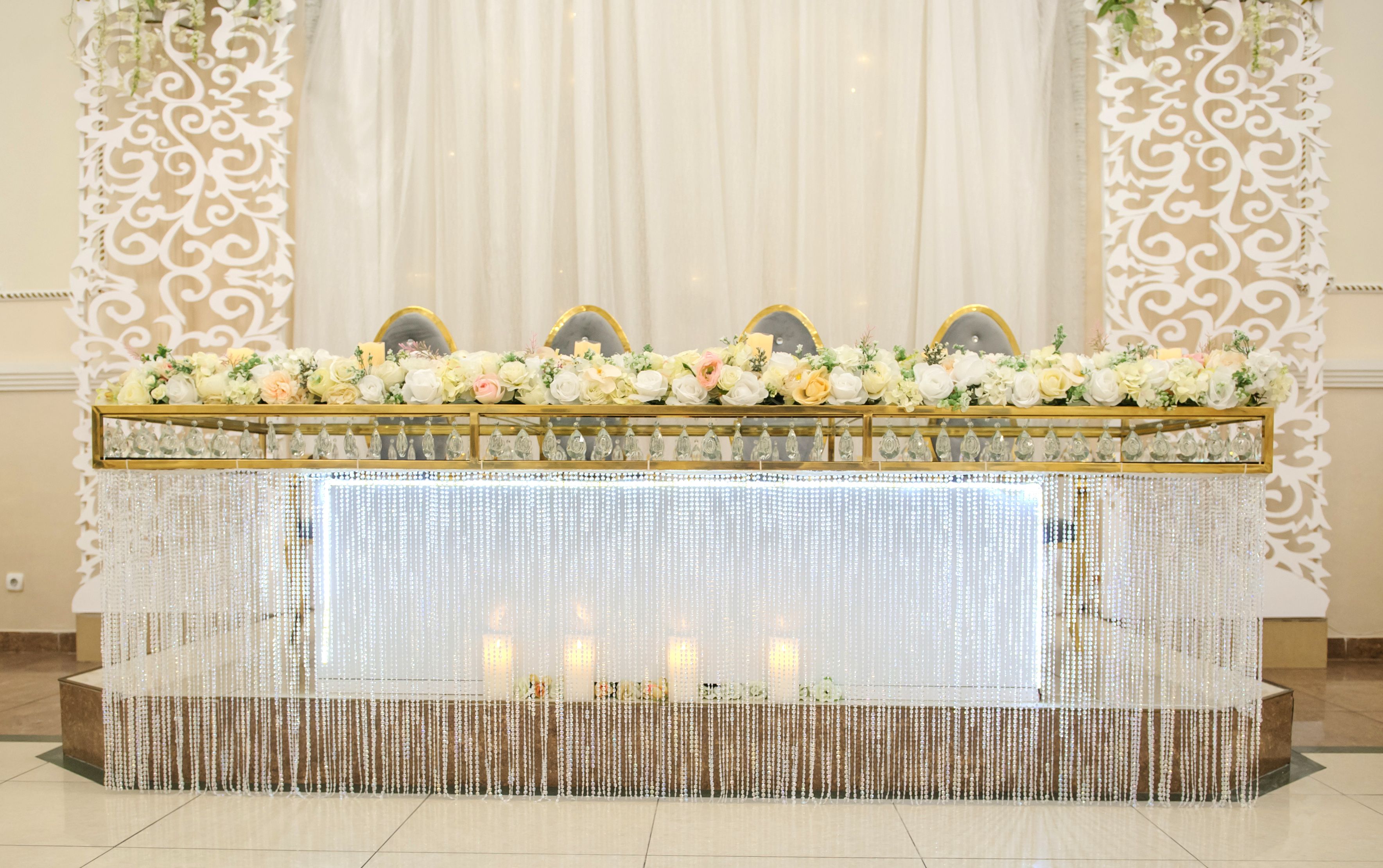 wedding presidium table at the banquet with white flowers and candles