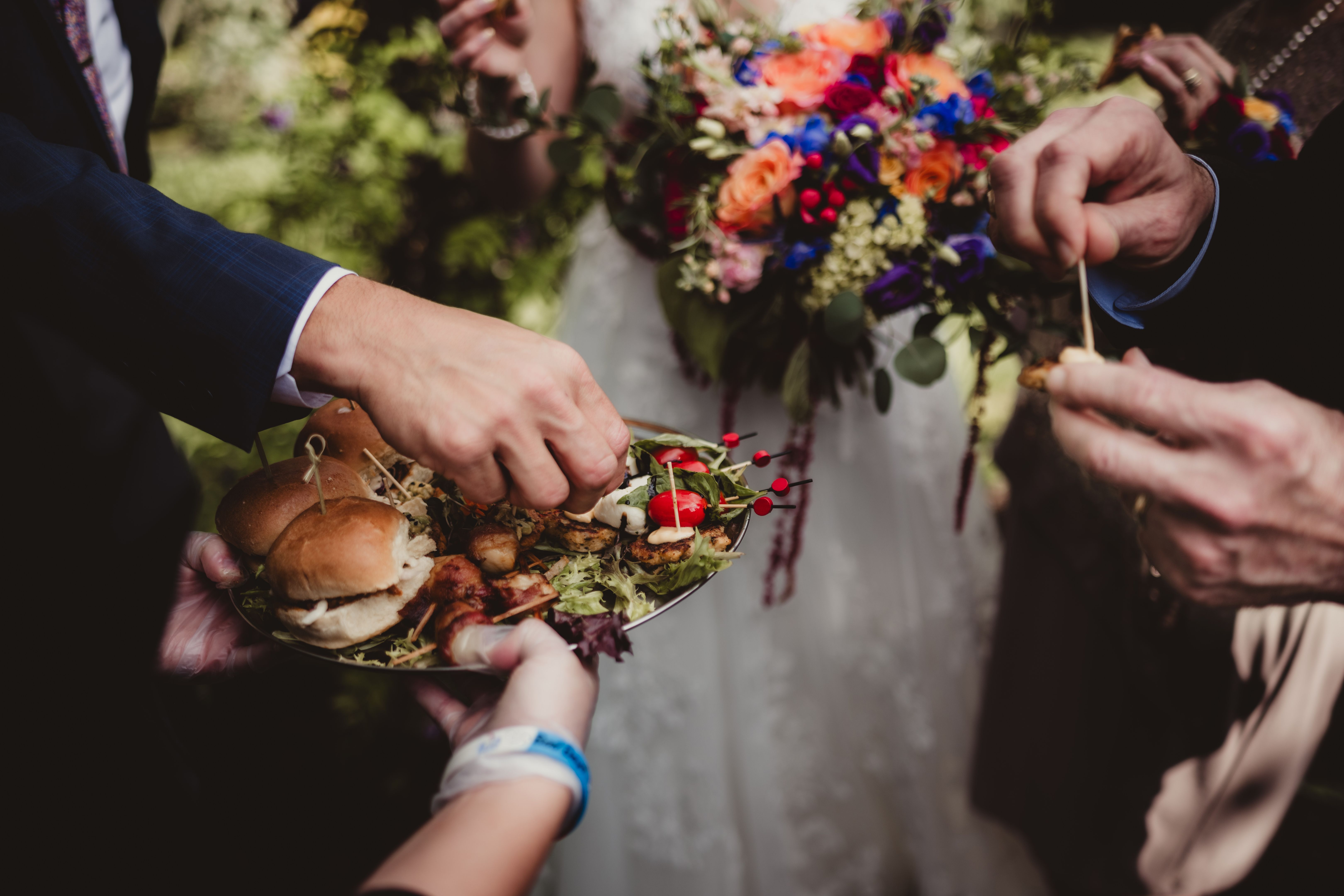 Wedding reception with appetizer tray being passed by waiter Wedding reception with appetizer tray being passed by waiter