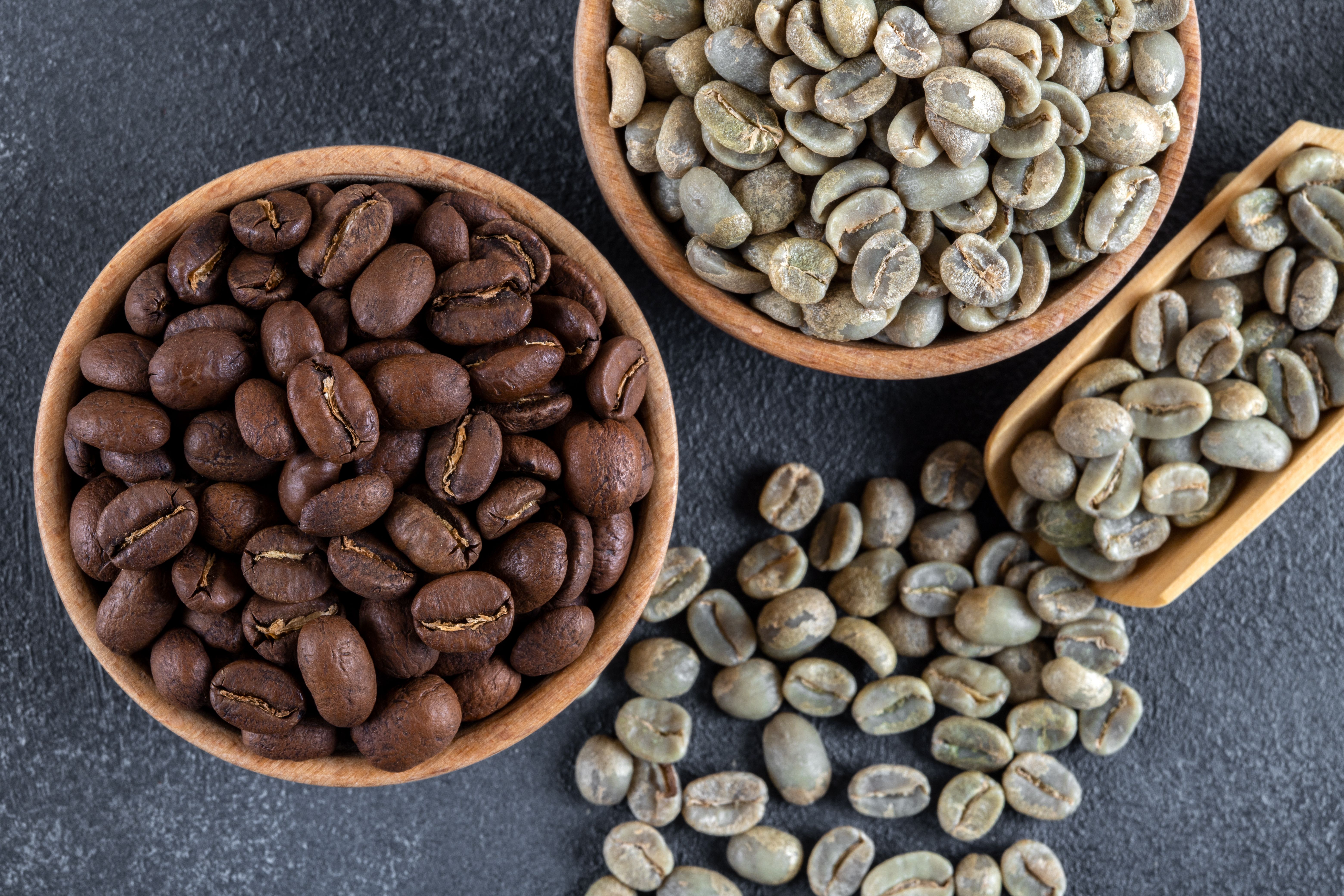 Ground coffee with roasted coffee beans on dark background,above view Ground coffee with roasted coffee beans on dark background,above view