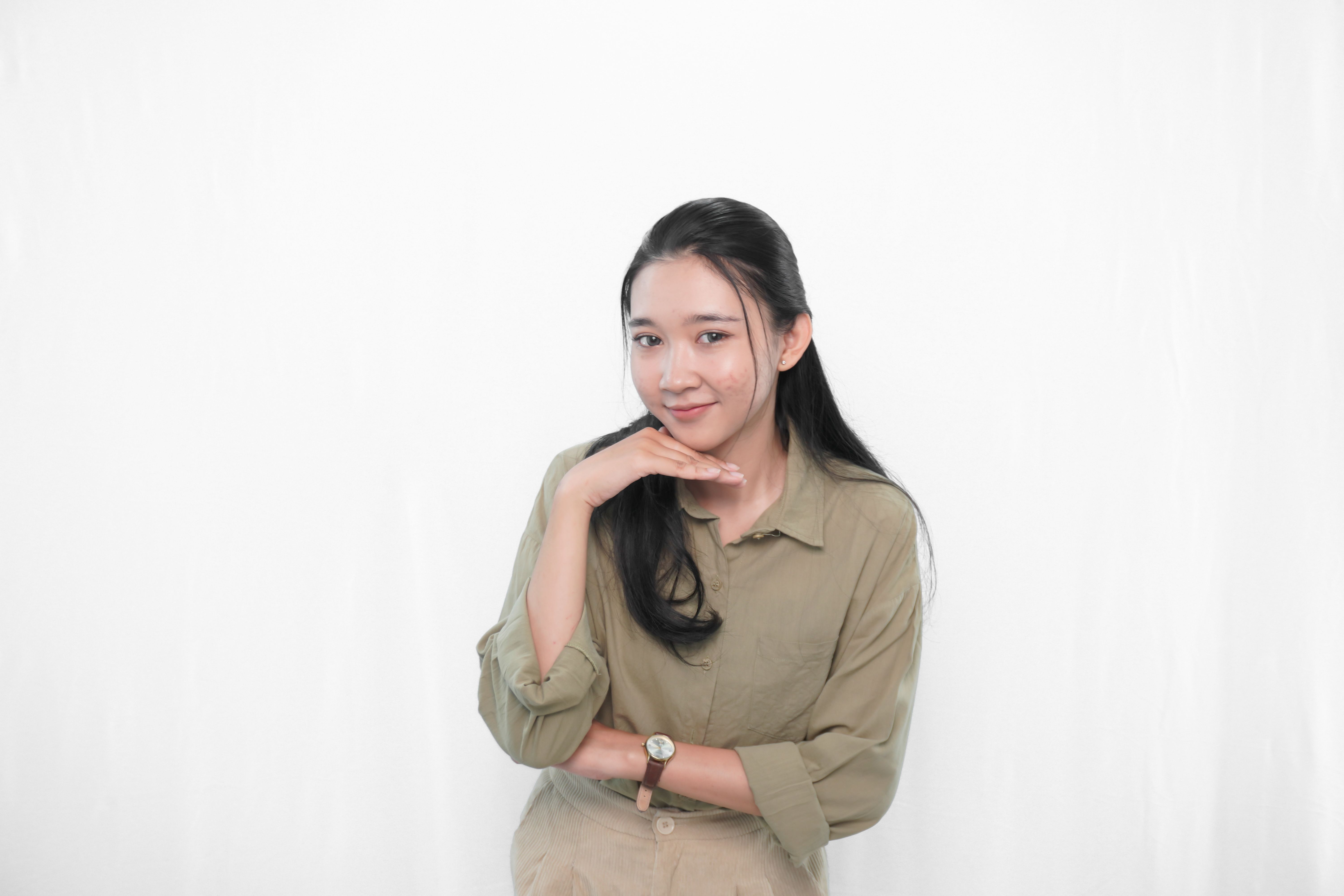 Expression of Indonesian Asian woman in green dress in studio