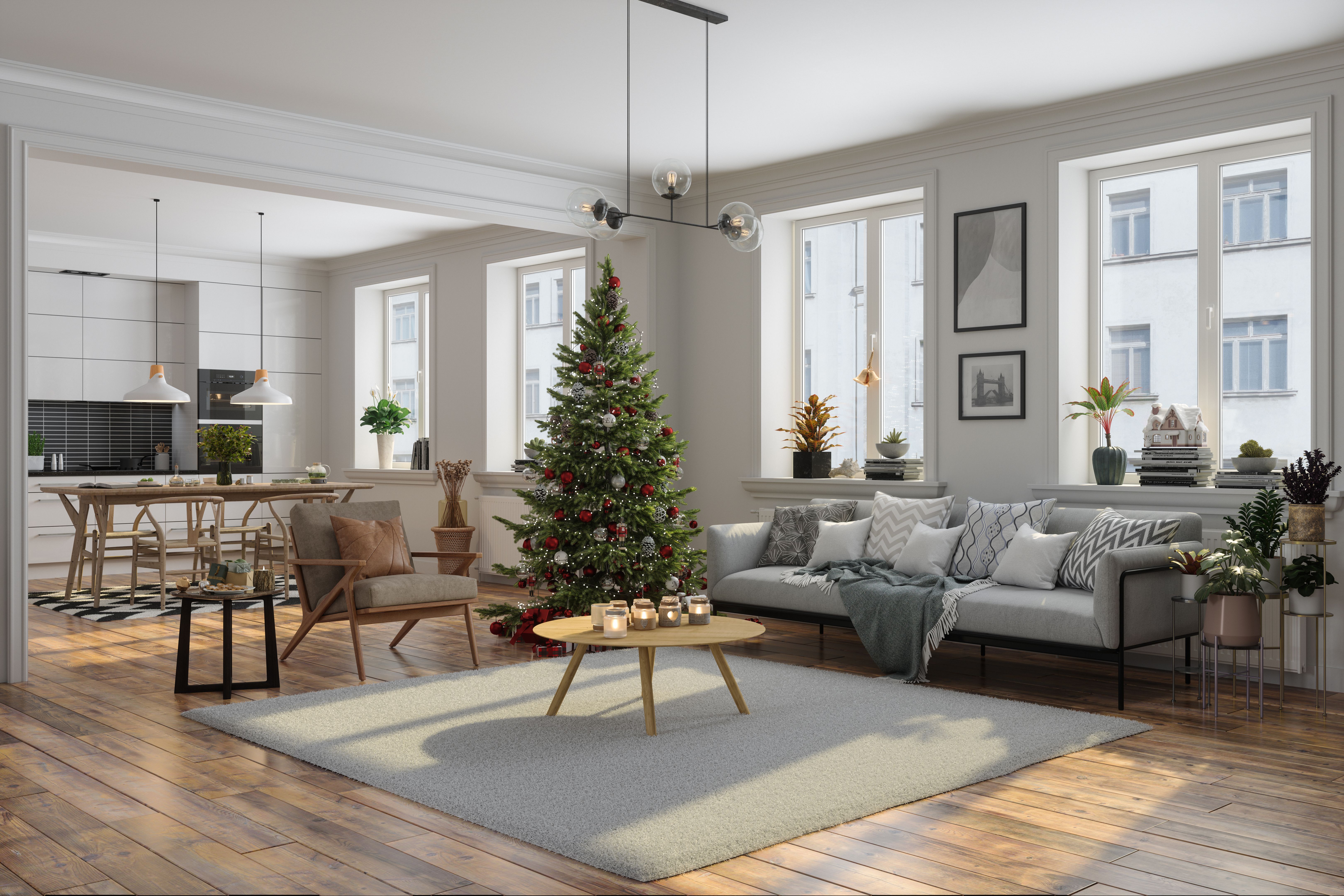 Modern Living Room Interior Decorated With Christmas Tree, Ornaments And Gift Boxes. Open Plan Kitchen With Wooden Dining Table And Chairs