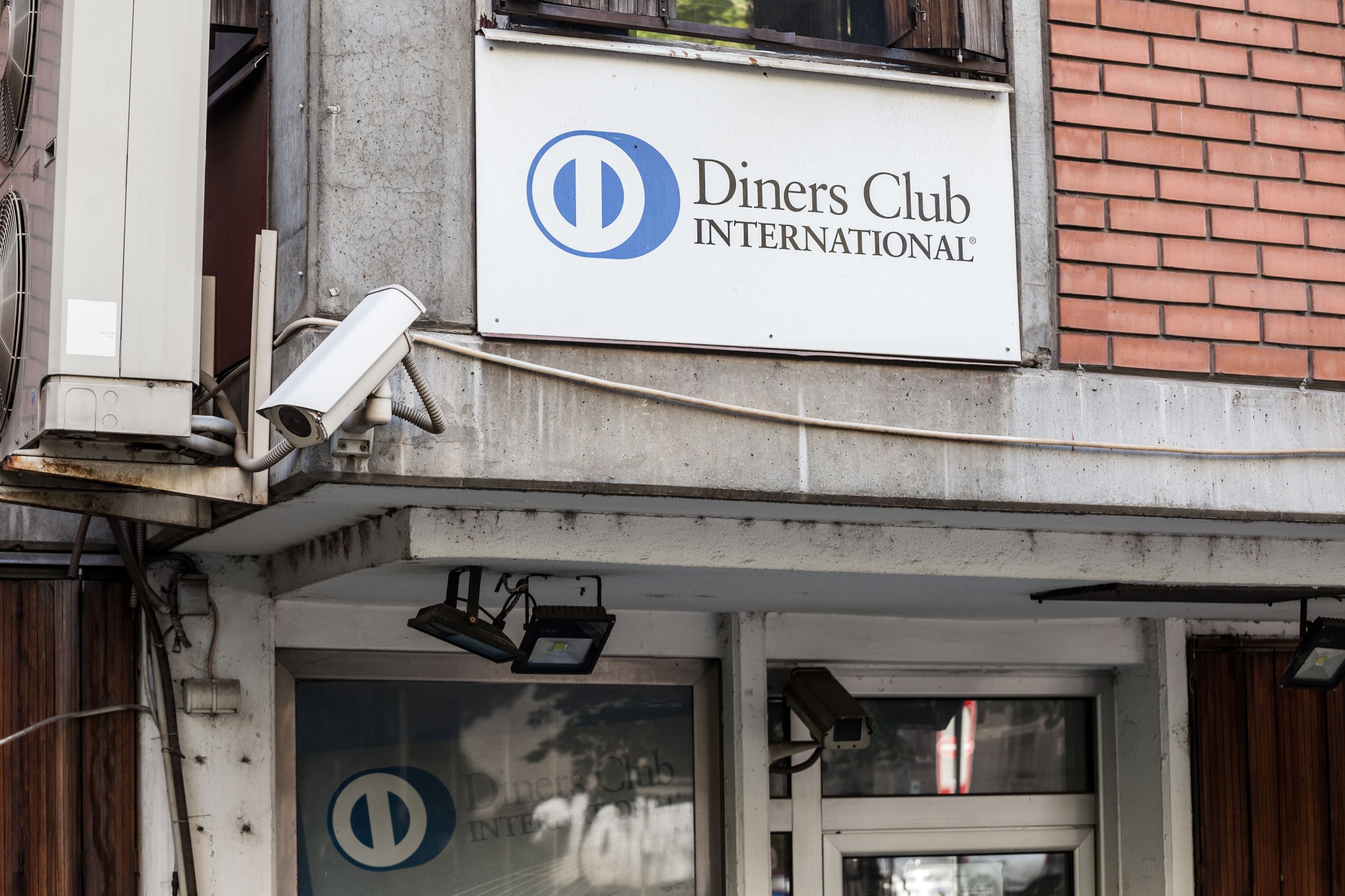 Diners club international logo in front of their office for Serbia. Diners club is a charge card and credit card company part of Discover Financial services. Diners club international logo in front of their office for Serbia. Diners club is a charge card and credit card company part of Discover Financial services.