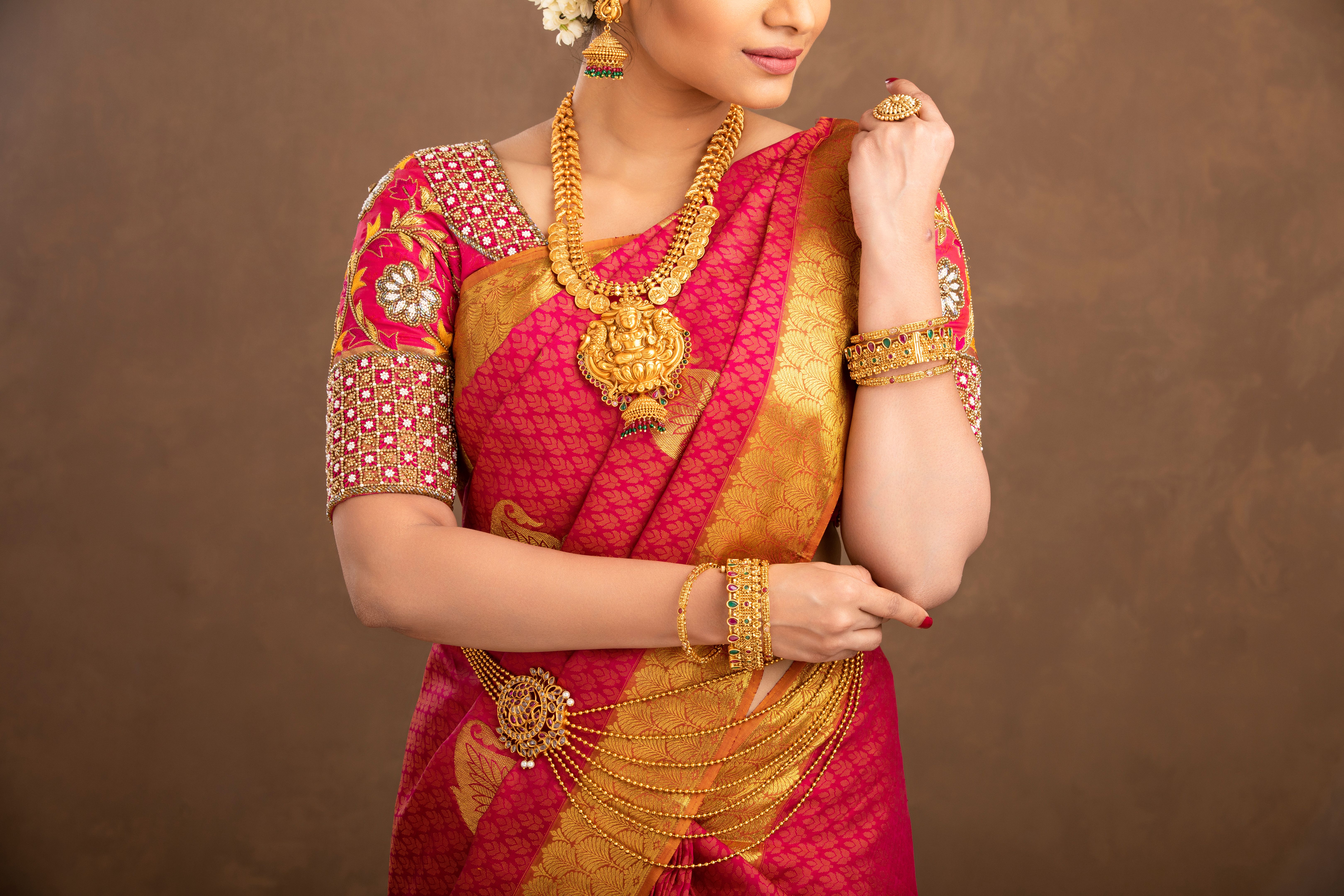 Beautiful smiling Indian bride with jewelry in studio shot.