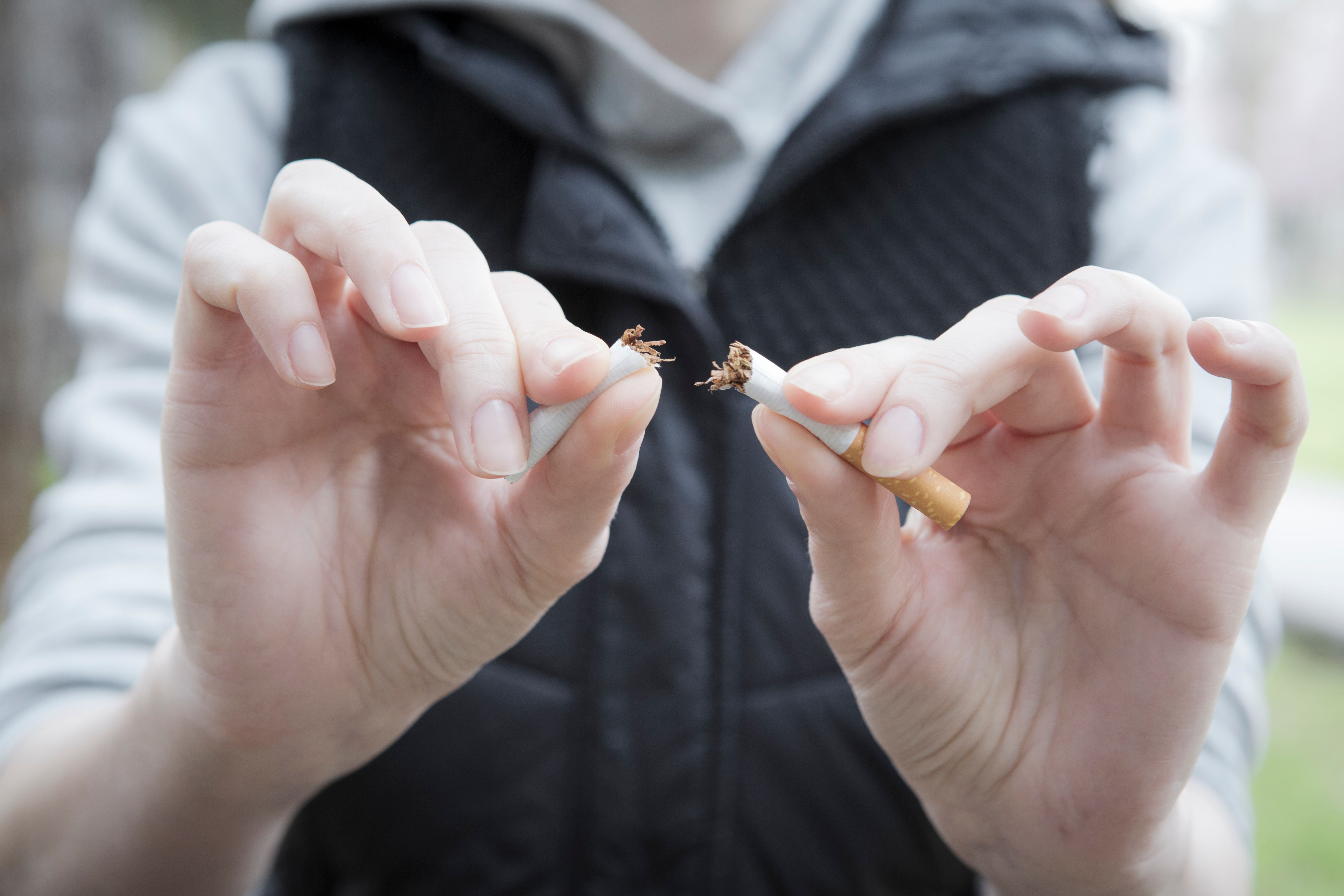 Woman breaking a cigarette
