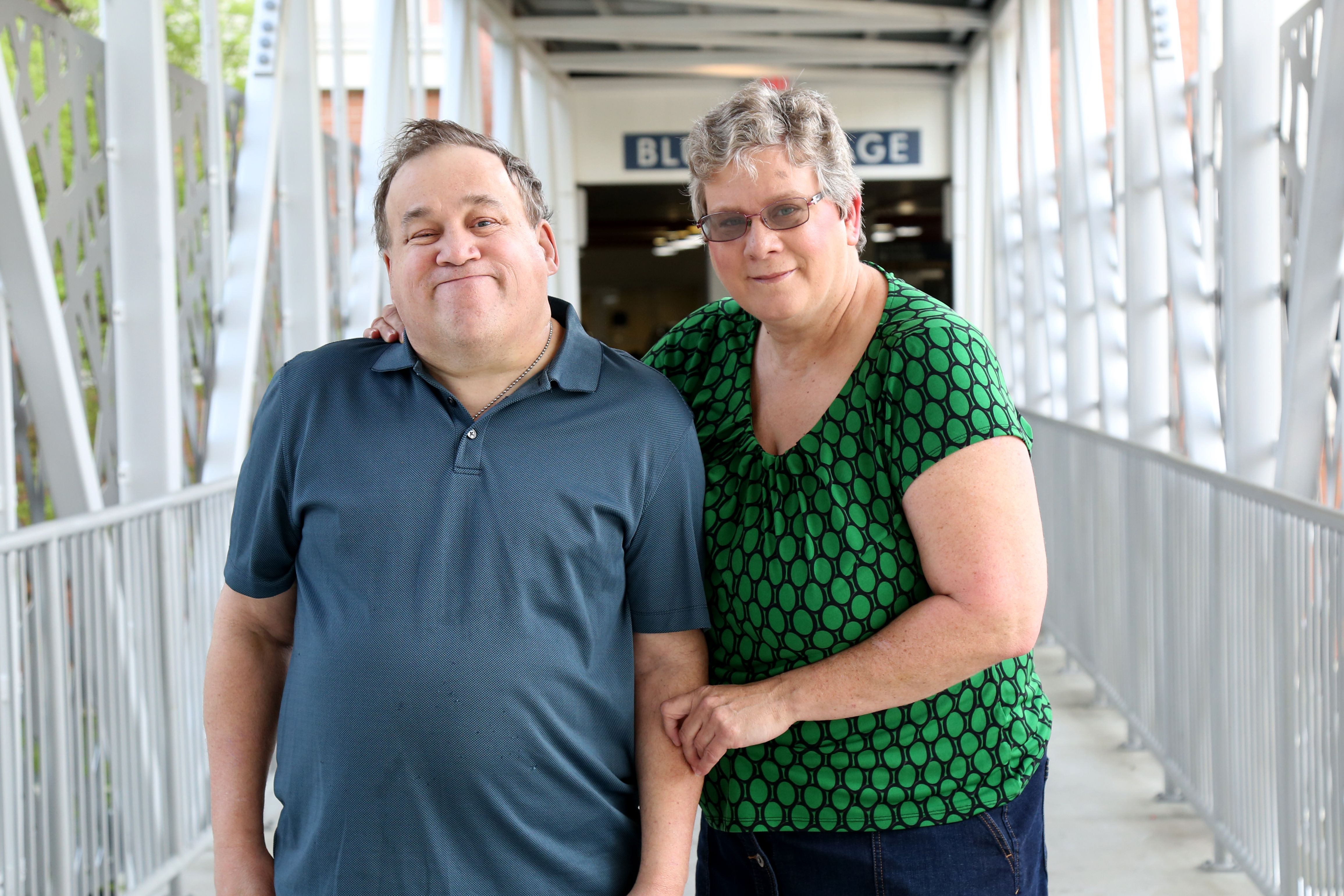 Mature adult female sits next to her Autistic brother
