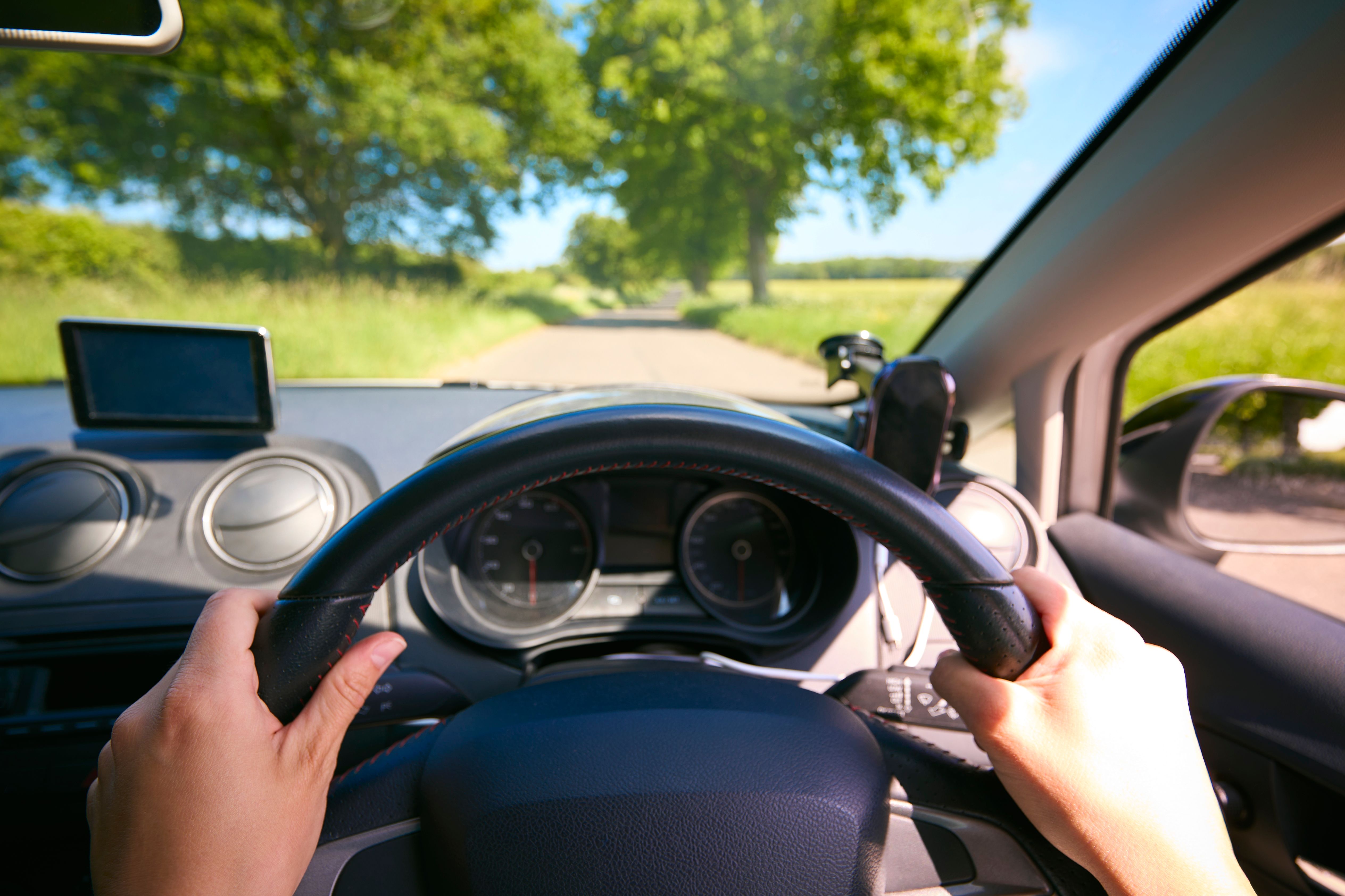 POV Shot Of Woman's Hand On Steering Wheel Driving, state anxiety