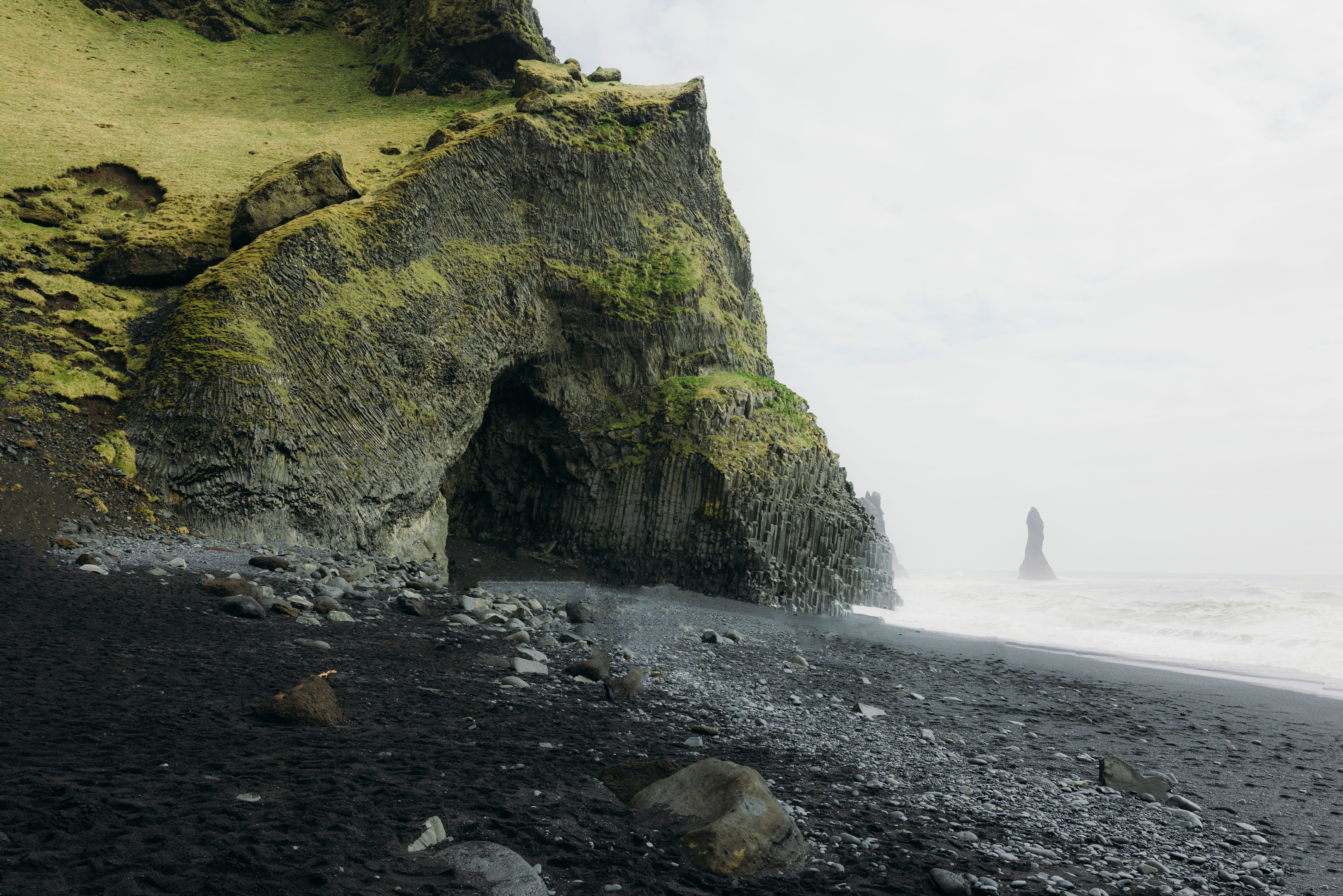 Dramatic Nordic Landscape with Black Sand Beach and Basalt Column Cliffs With Storm at Ocean