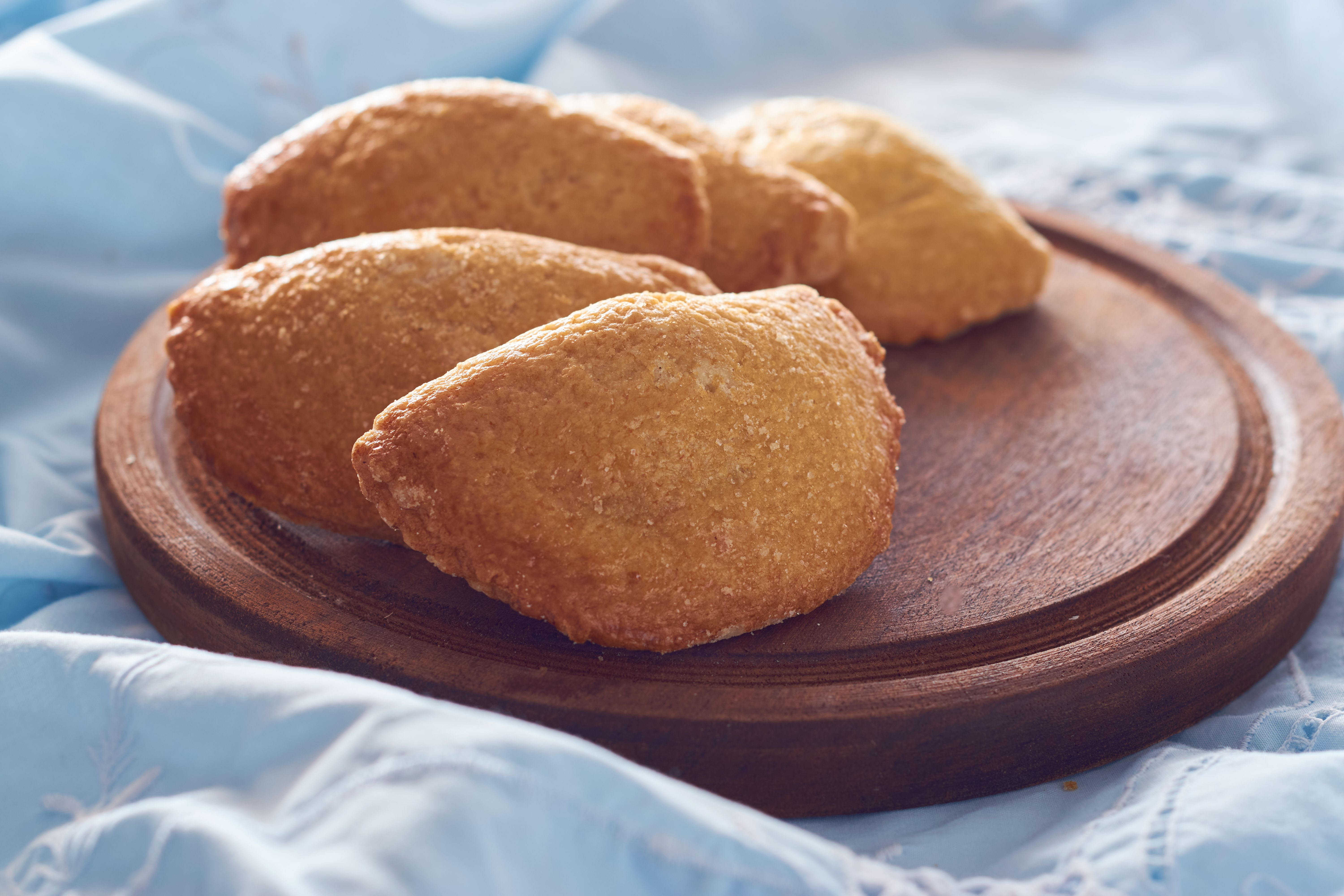A closeup of Argentinian sweet empanadas with dulce de leche