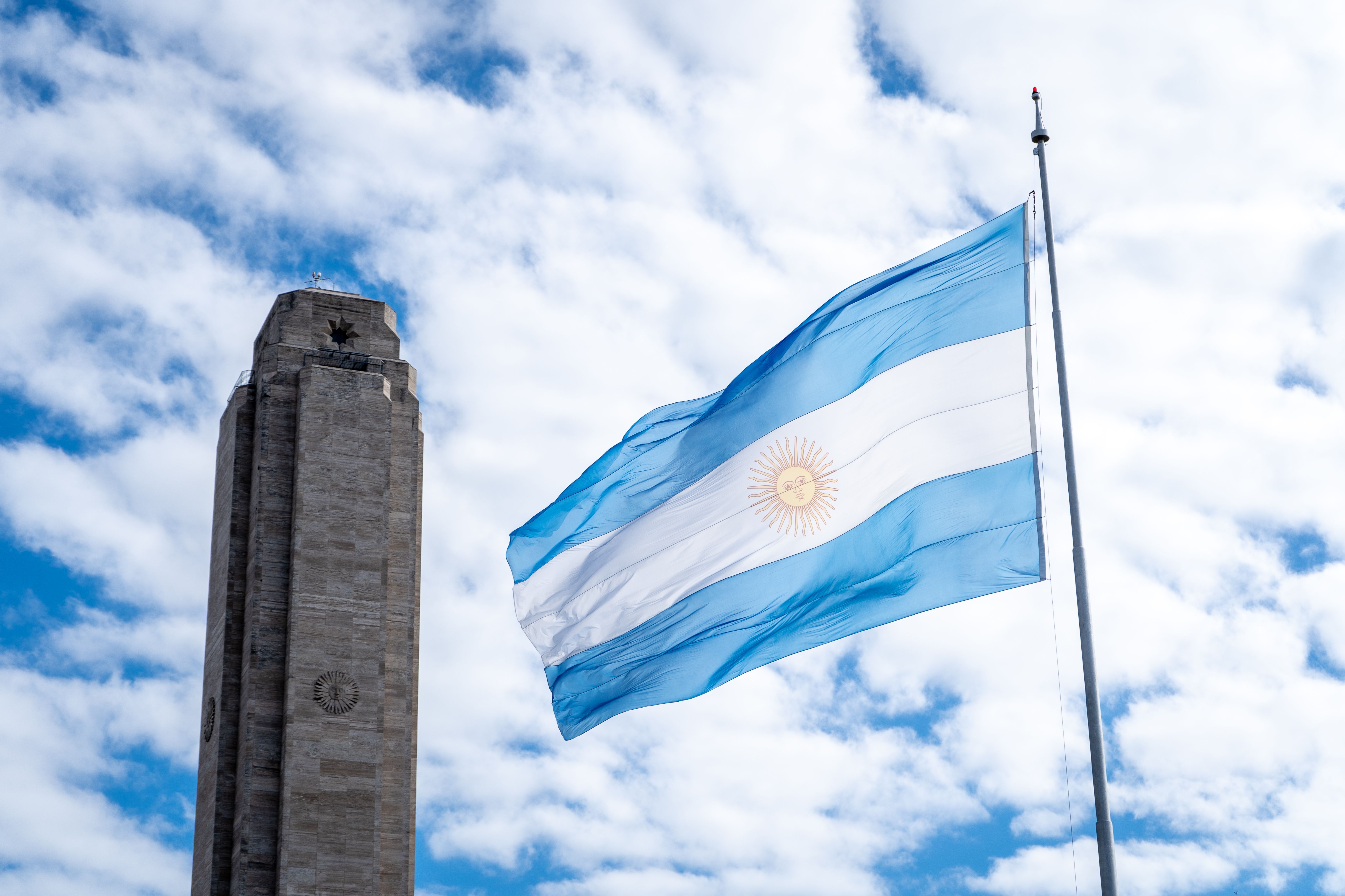 Argentine flag flying in front of the flag monument in the city of Rosario.