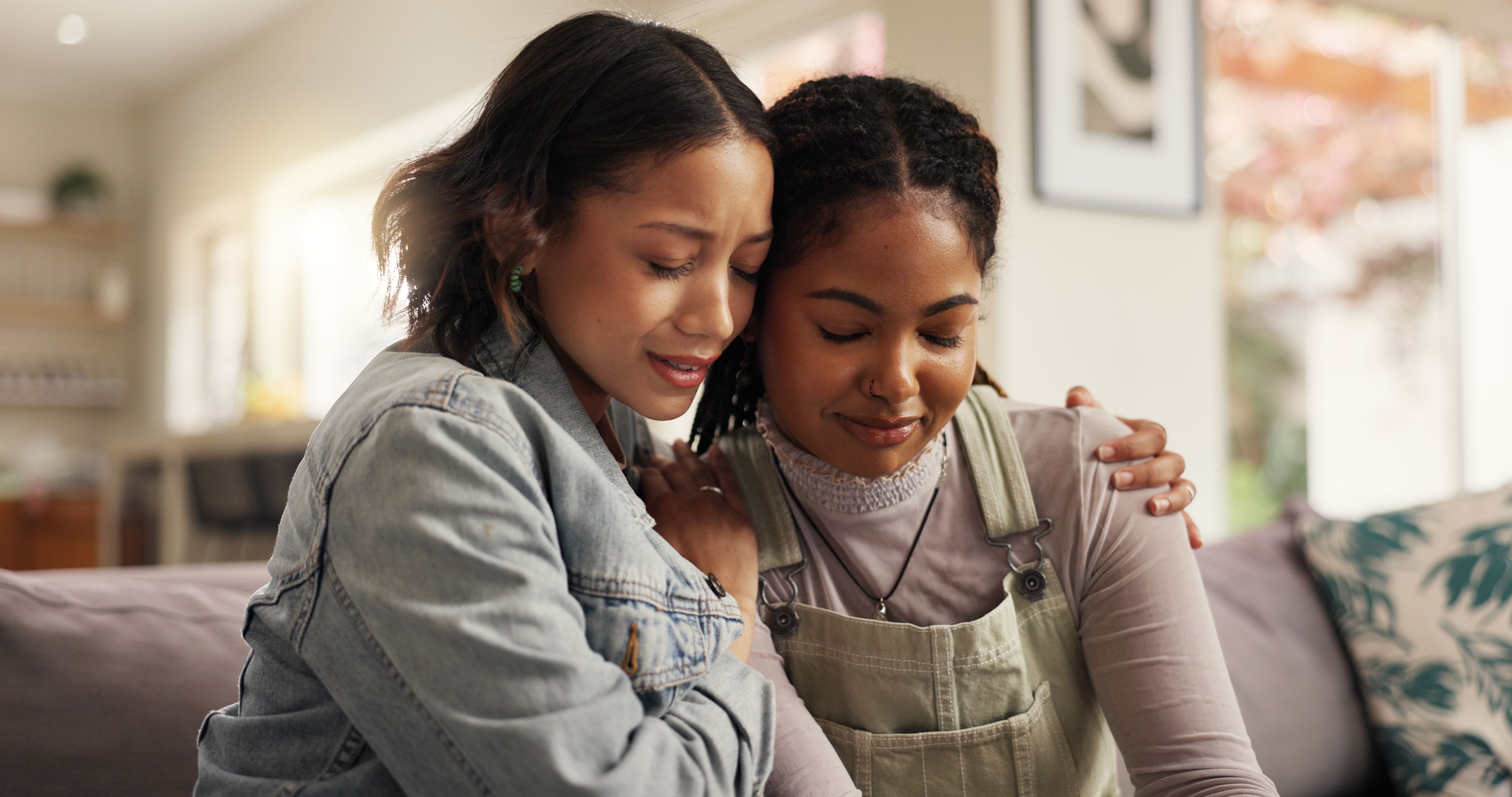 Sad, women and hug with friends on couch for comfort with breakup or relationship fail in home. Support, people and empathy for cheating mistake, console and kindness for mental health in living room