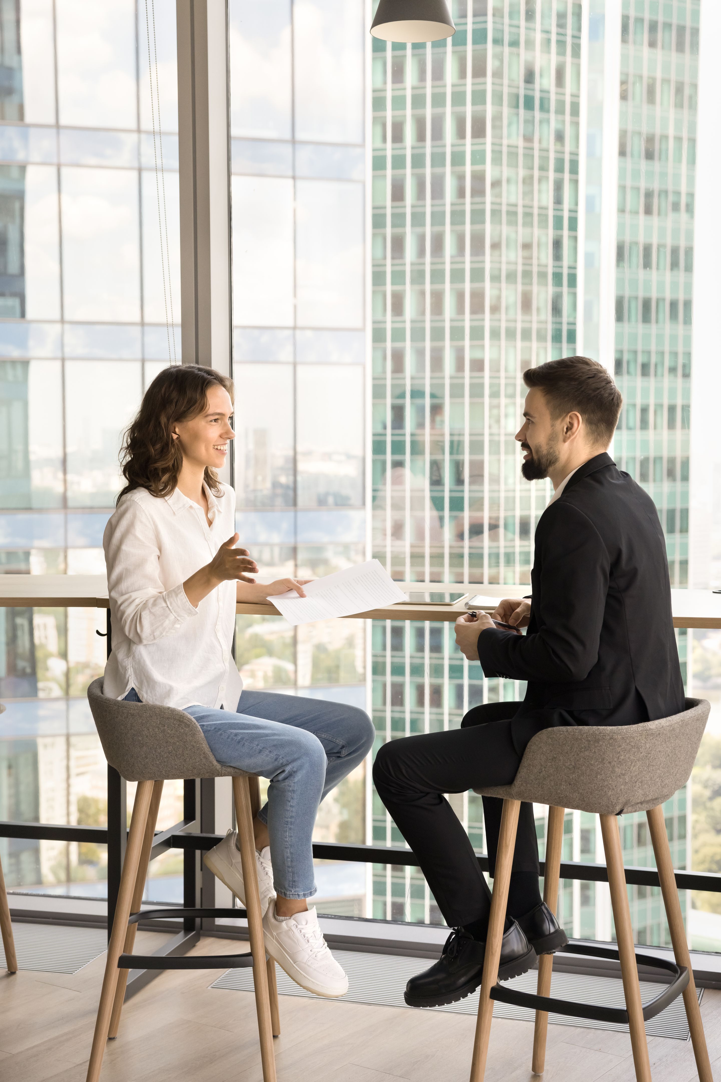 Two young entrepreneurs discussing cooperation in co-working