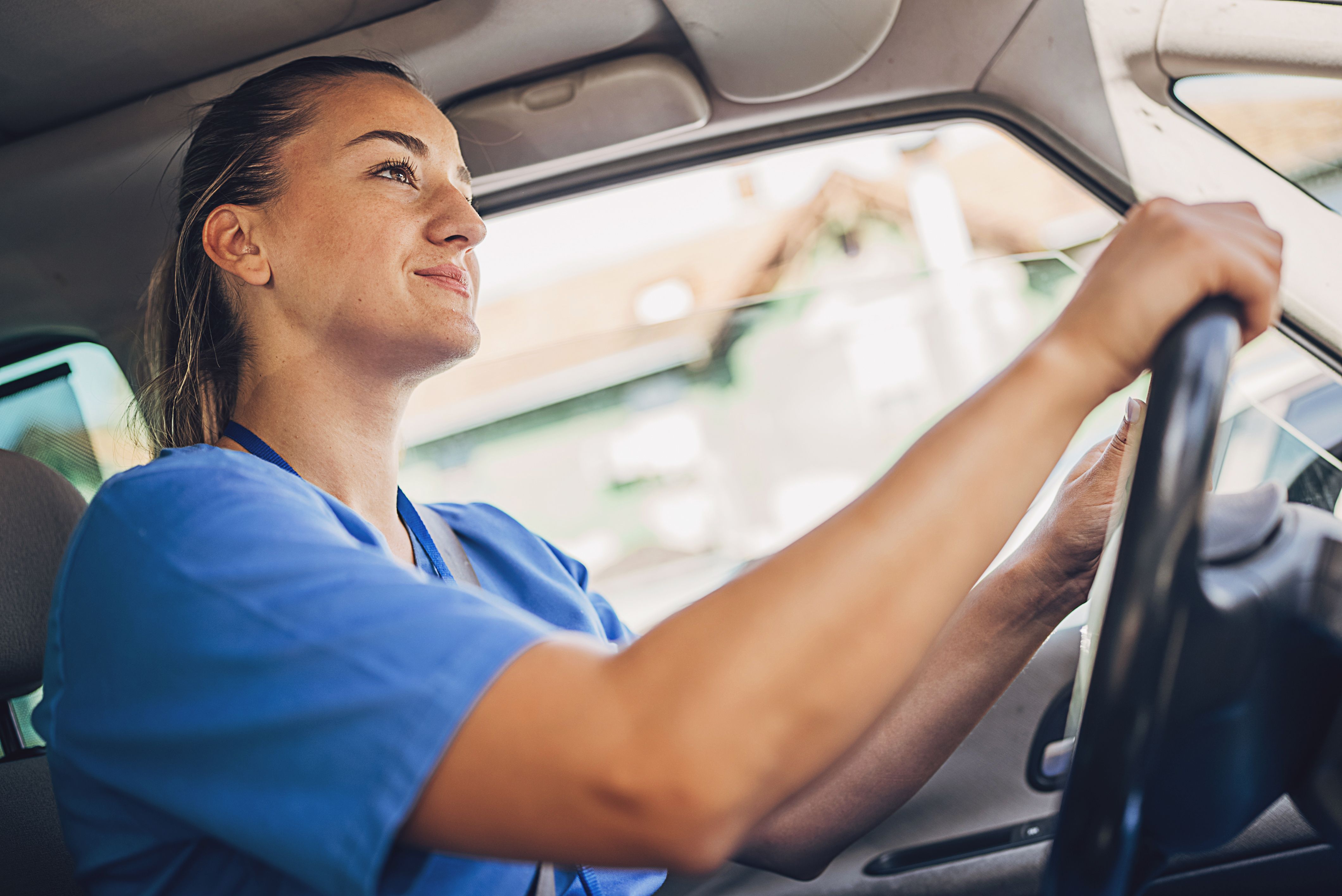 Female nurse driving car and going to work