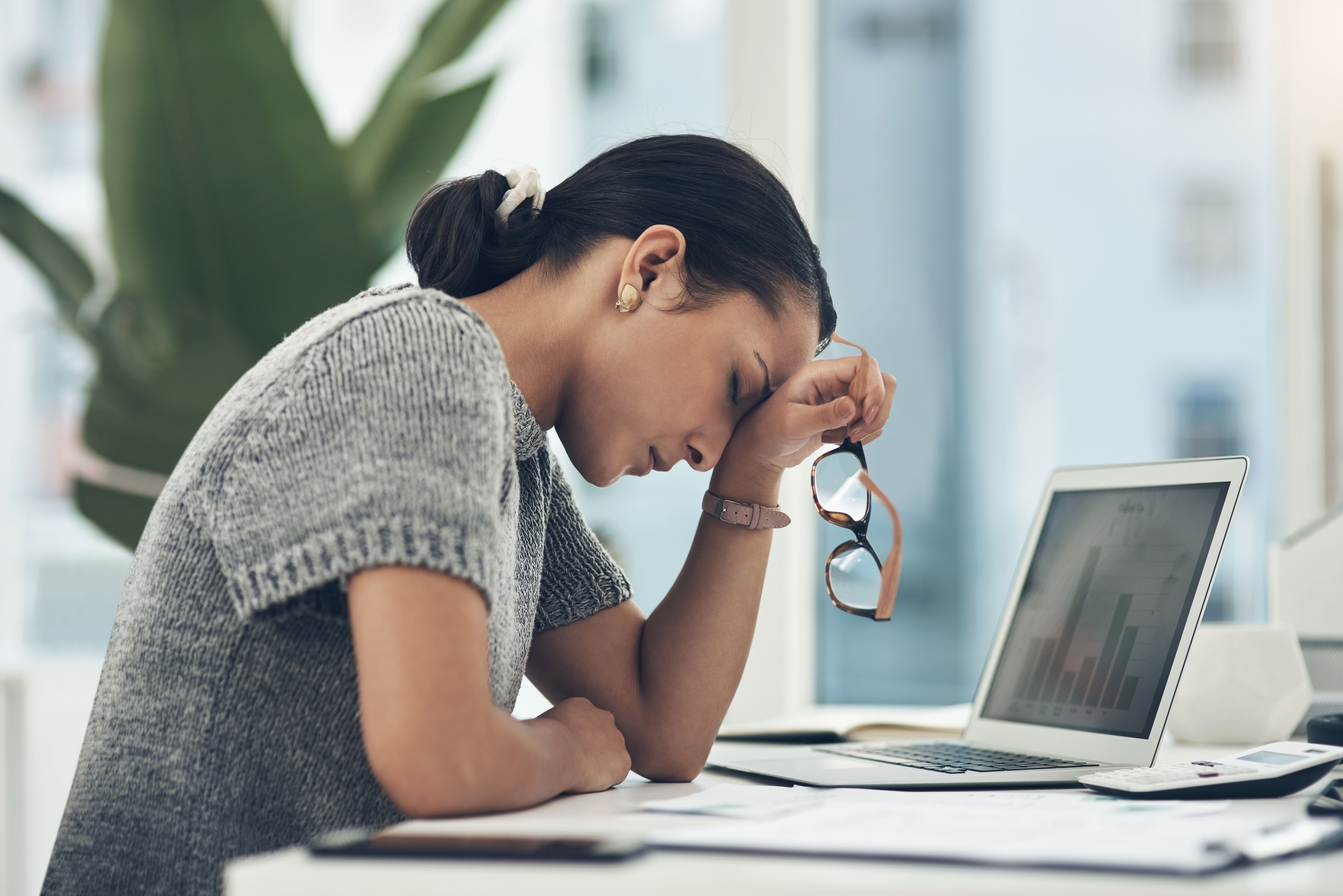 Shot of a young businesswoman looking stressed out while working in an office Shot of a young businesswoman looking stressed out while working in an office