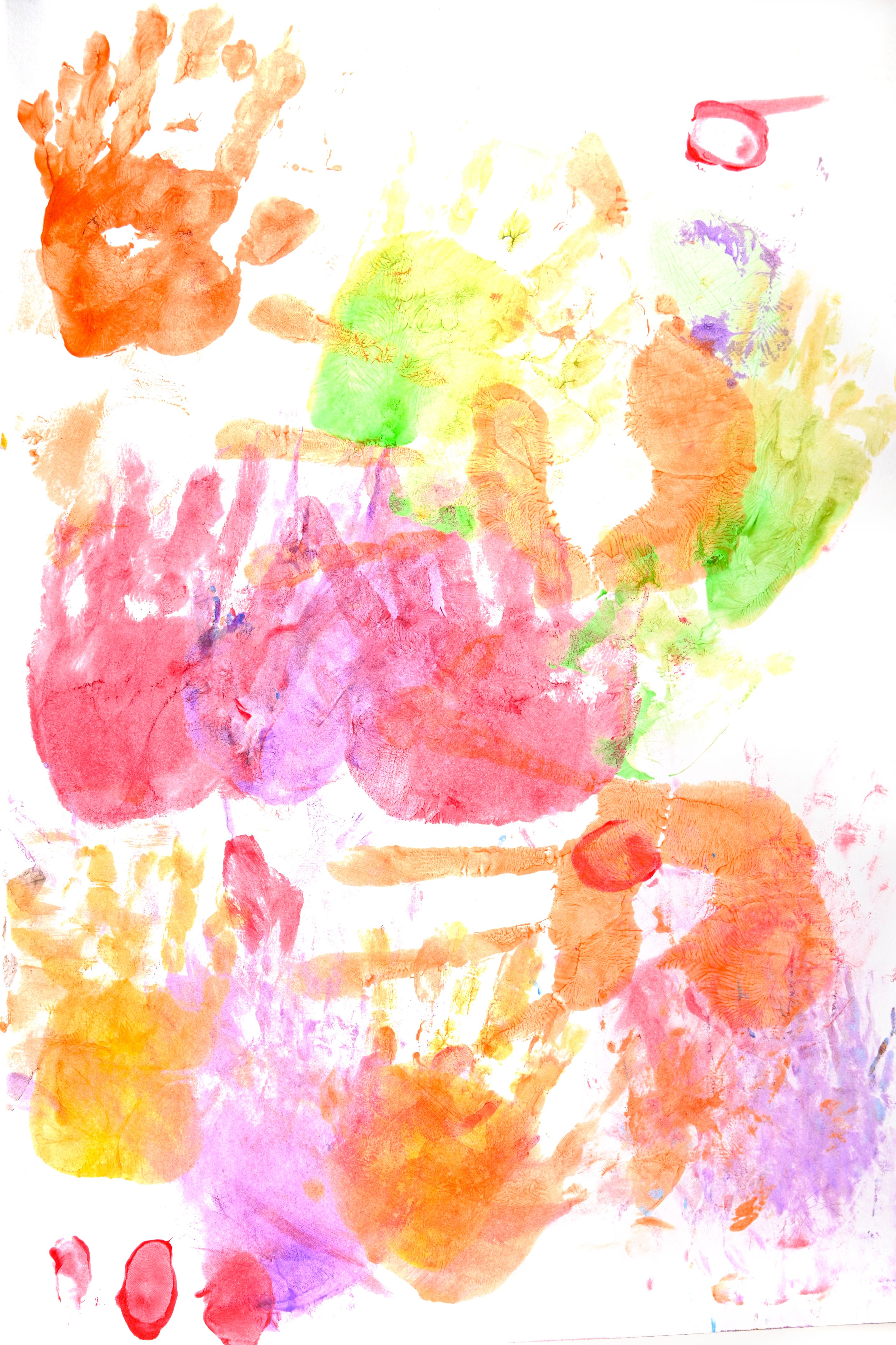 Colorful children's hand prints on a white background.