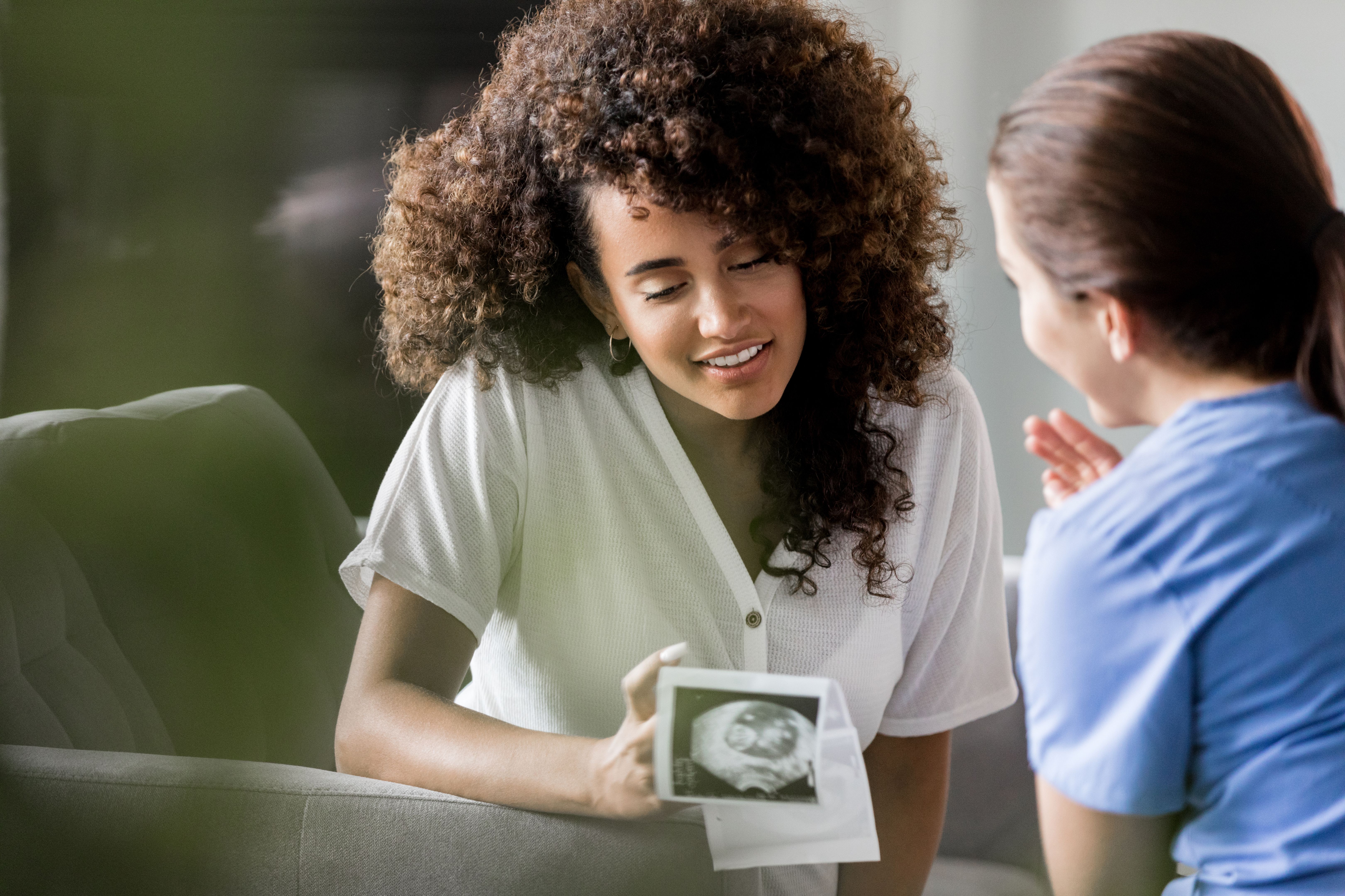 Excited expectant mom looking at ultrasound images
