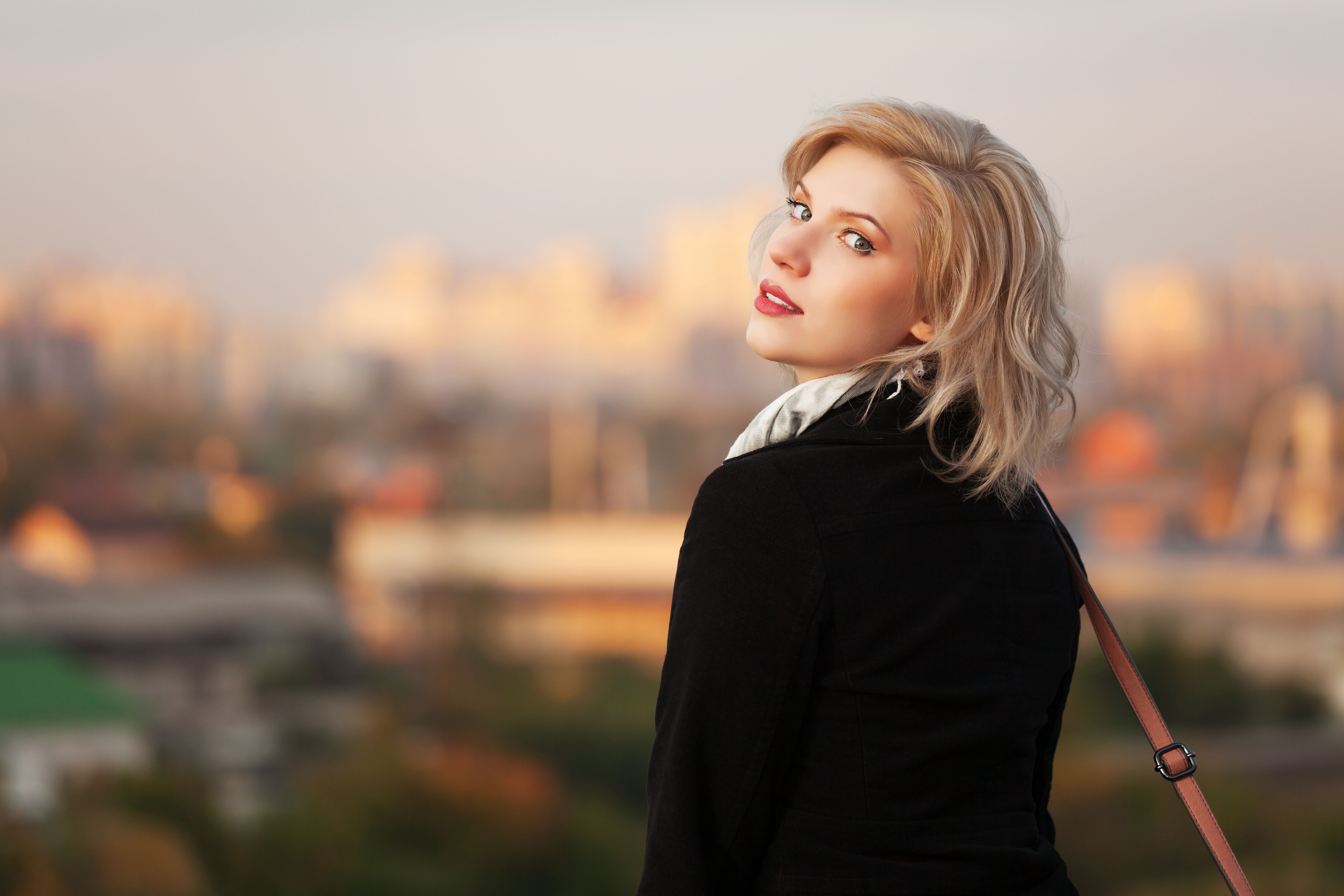Young woman against autumn urban background Young woman against autumn urban background