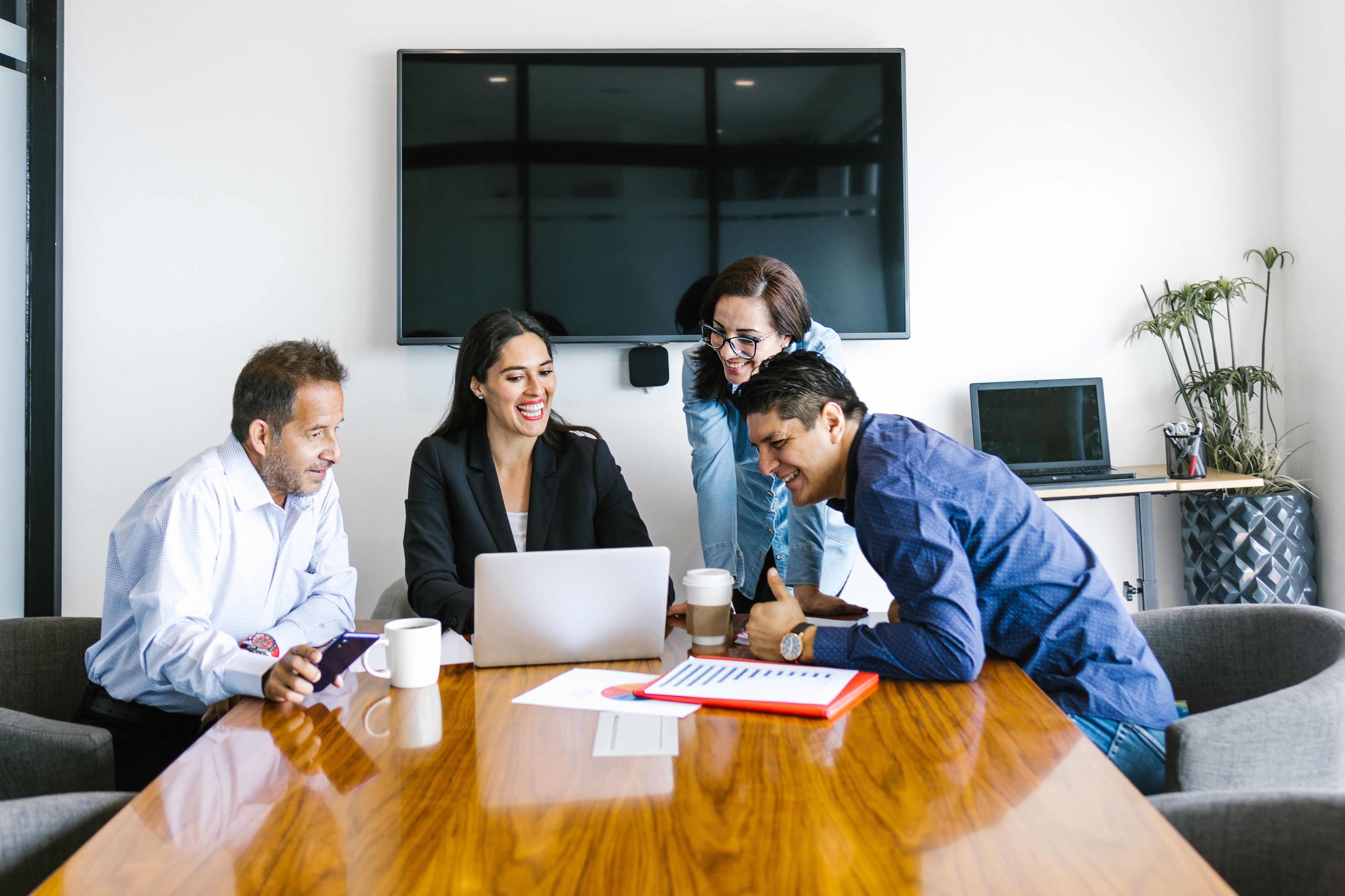 Group of hispanic people doing teamwork in office using digital devices in Latin America