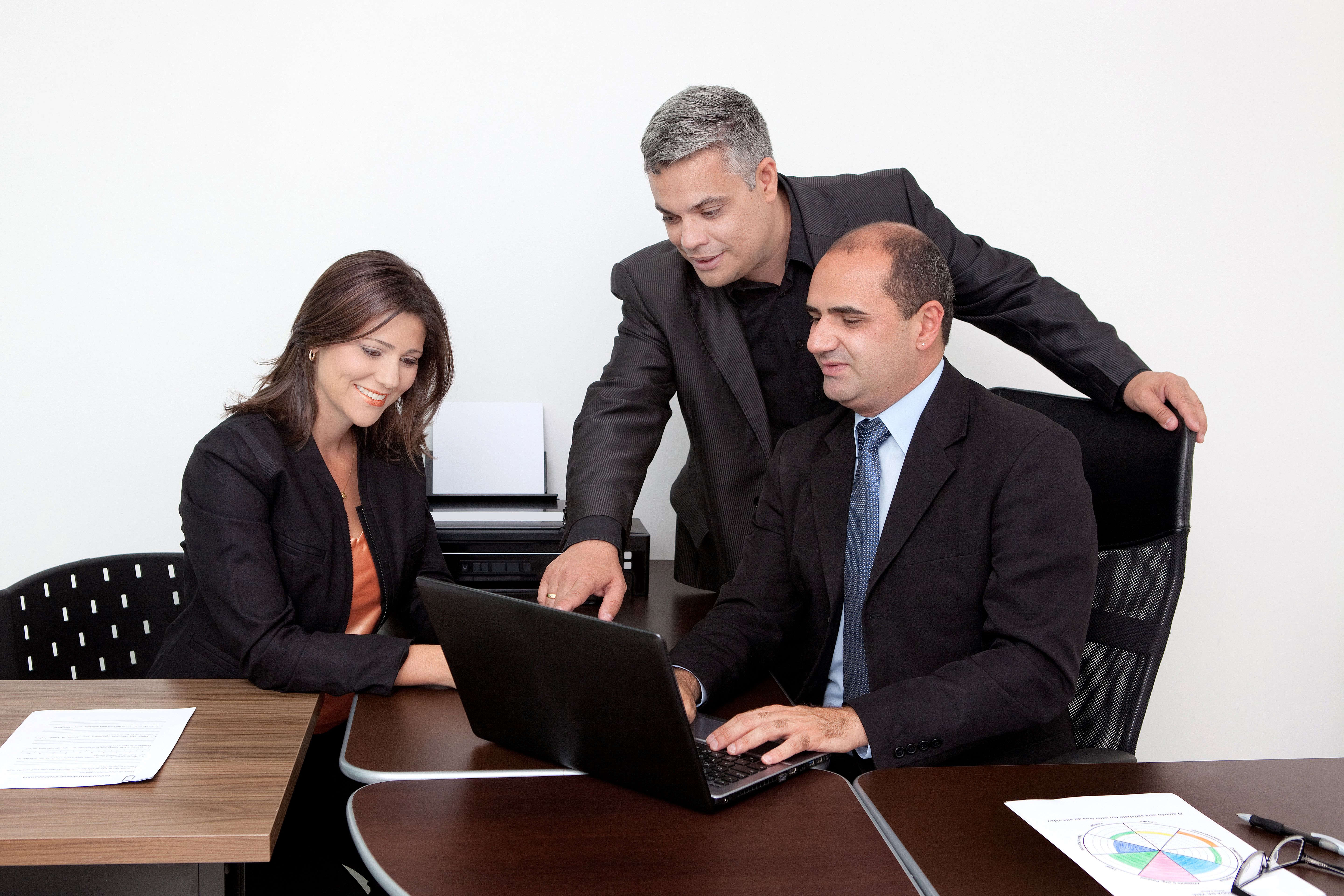 Latin Business Coach Giving Instructions Pointing at Laptop at Office