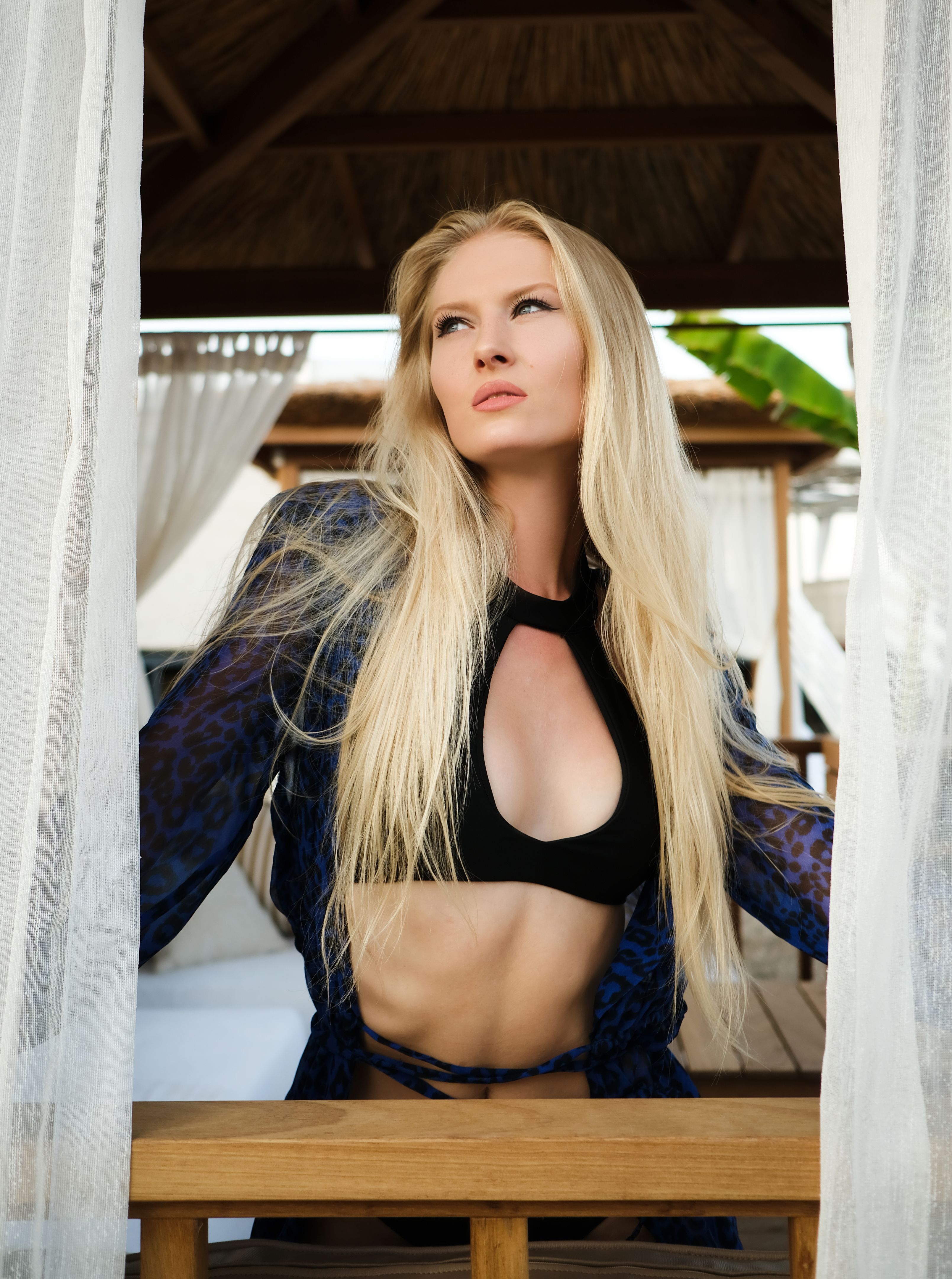 Portrait of beautiful blonde woman wearing bikini looking away. Portrait of beautiful blonde woman wearing bikini looking away.