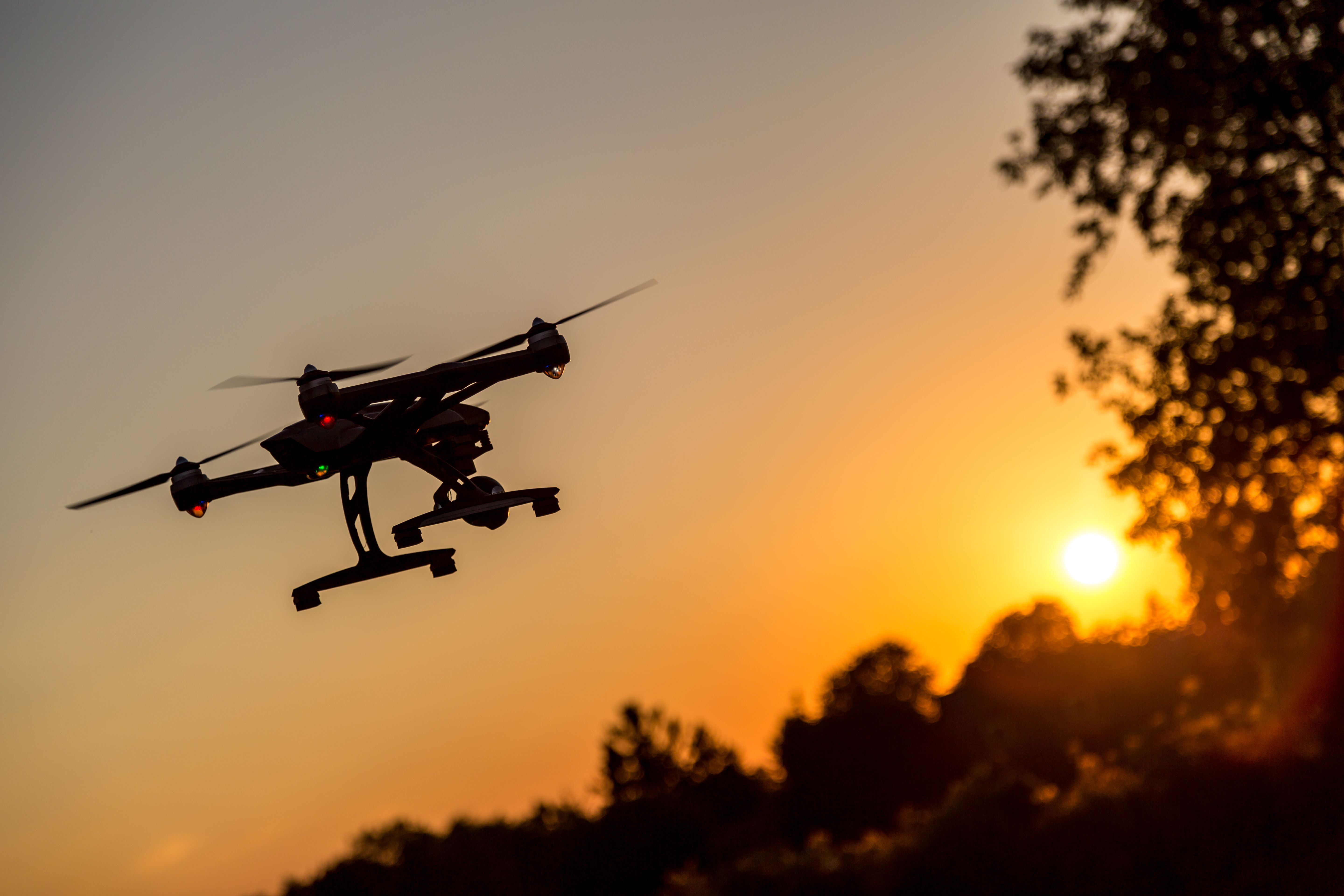 Drone Silhouette Flying At Sunset