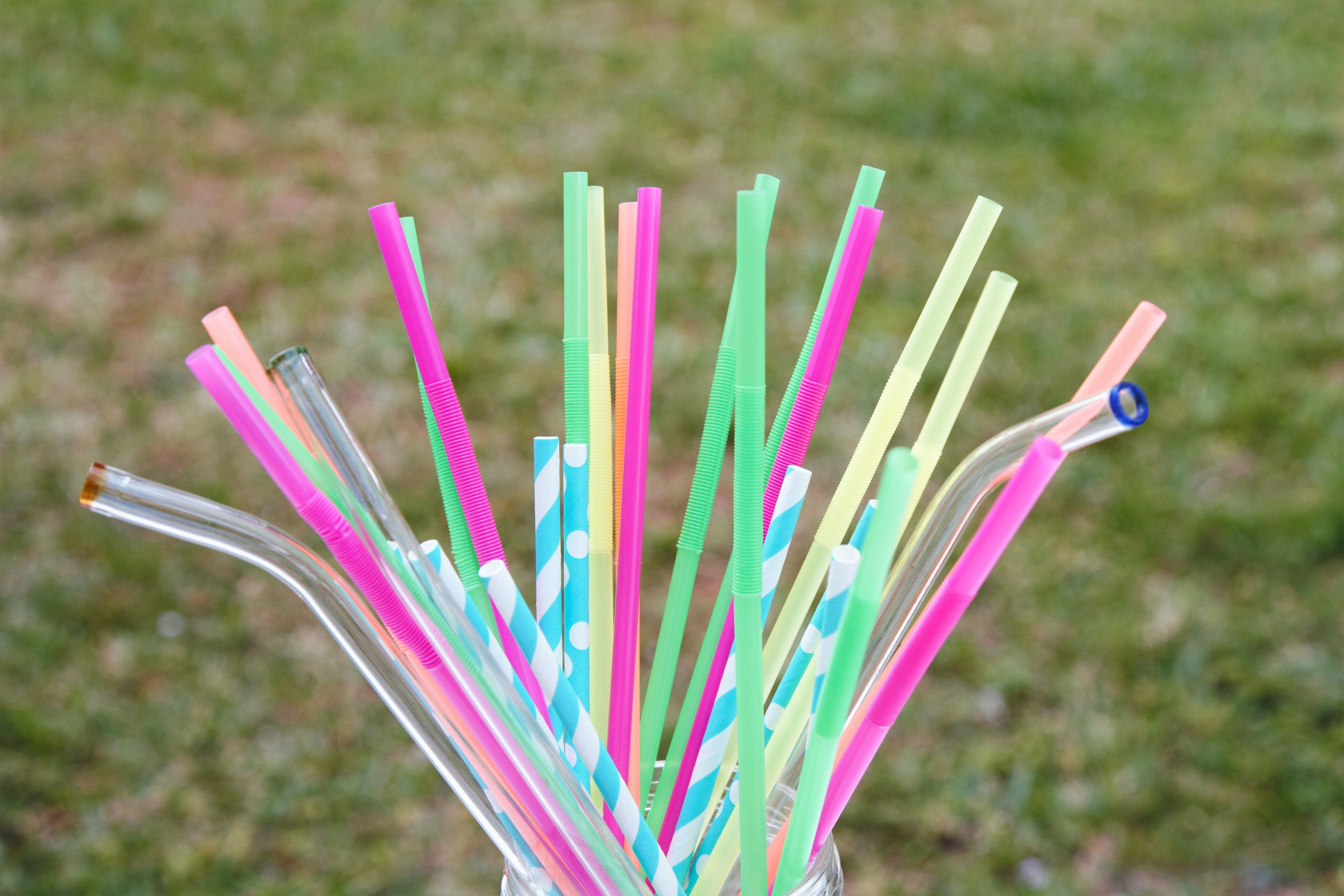Glass, paper and plastic straws in jar Glass, paper and plastic straws in jar