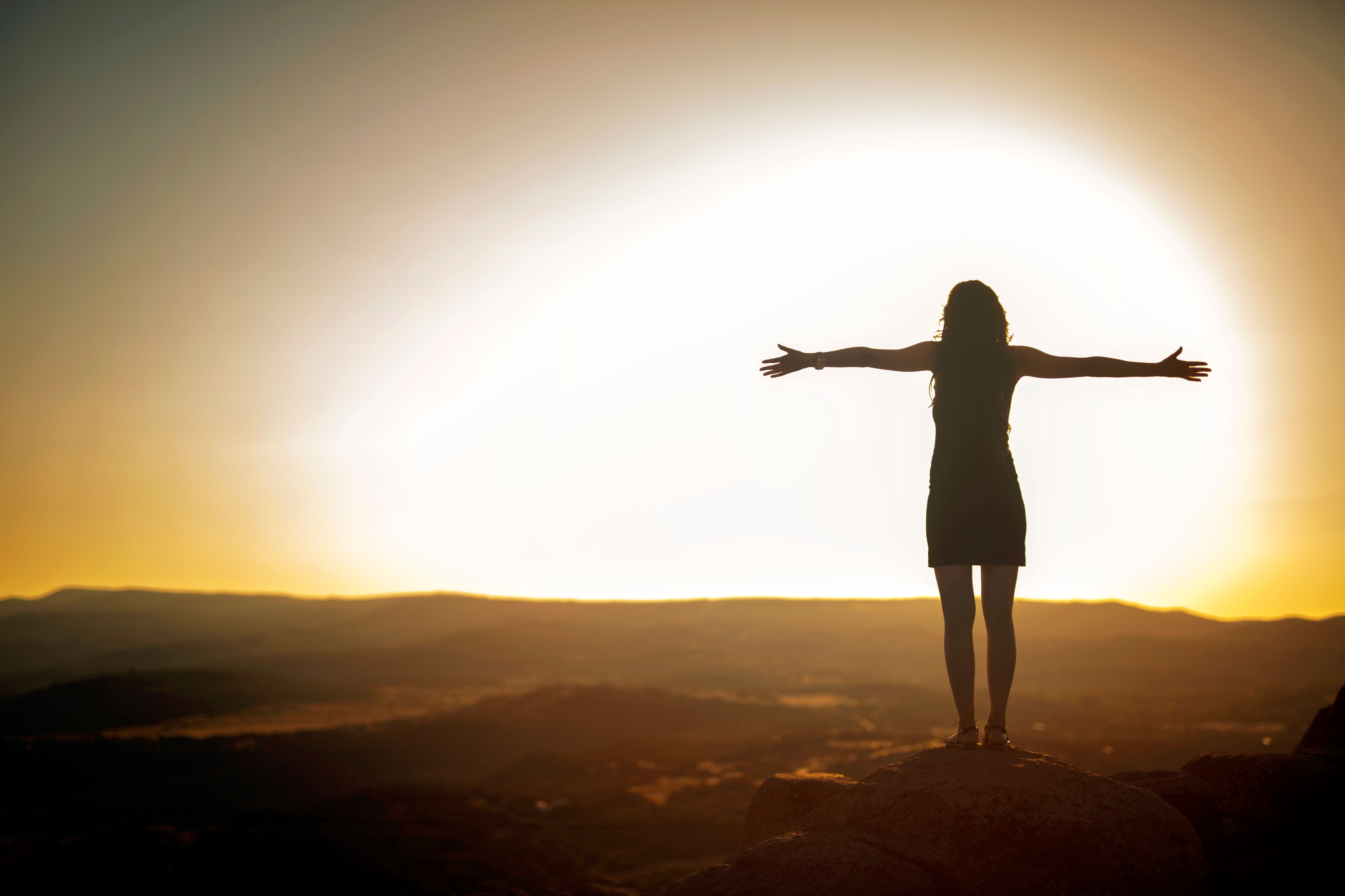 Woman Silhouette at sunset on hill
