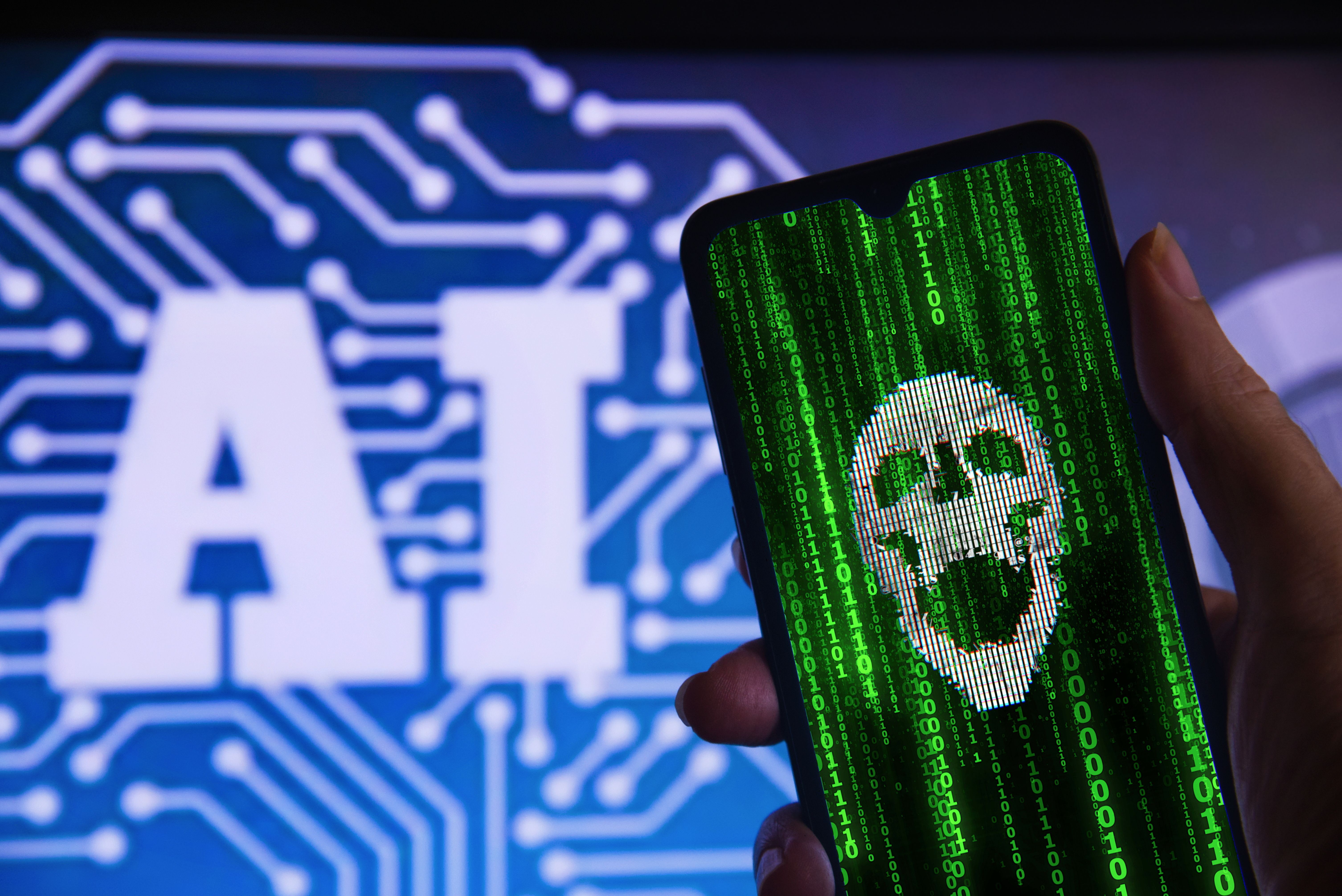 Hand holding a hacked cell phone with a skull (cyber attack), with the Artificial Intelligence (AI) symbol in the background. Concept of cyber attack, hacking and computer crime with AI. Hand holding a hacked cell phone with a skull (cyber attack), with the Artificial Intelligence (AI) symbol in the background. Concept of cyber attack, hacking and computer crime with AI.