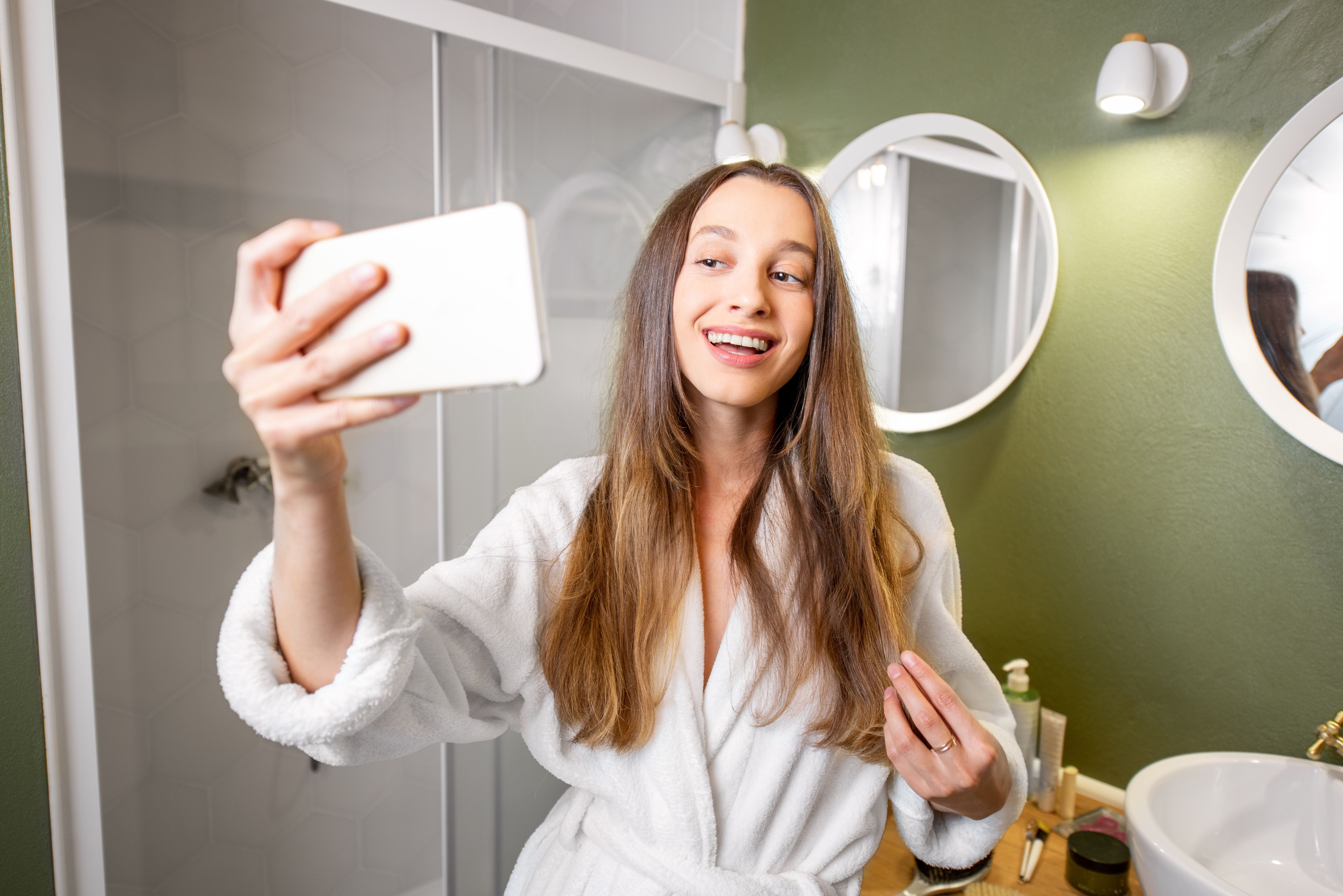 Woman making selfie photo in the bathroom Woman making selfie photo in the bathroom