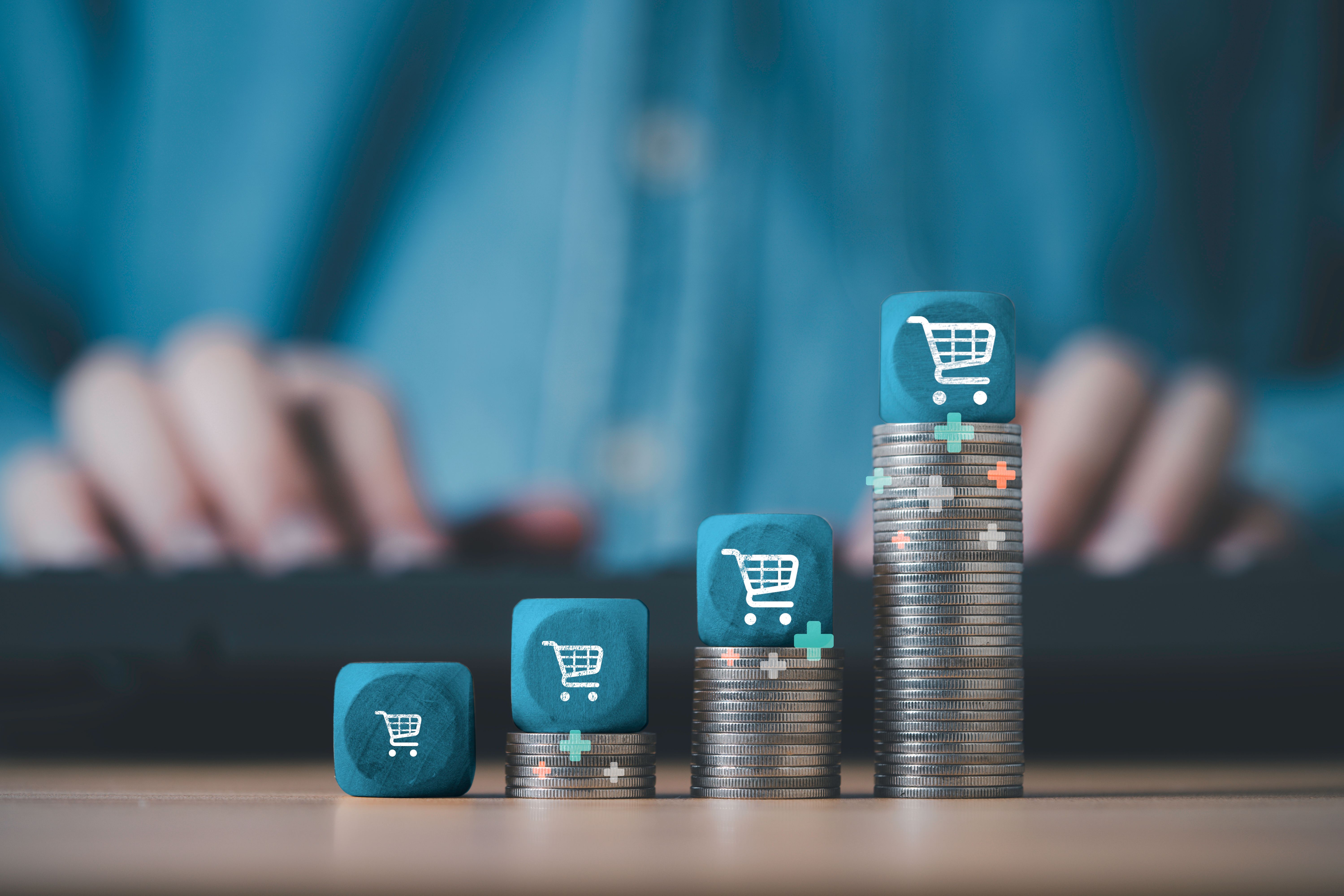 Shopping trolley cart stack on the top of increasing coins stacking for  online sale business growth concept.