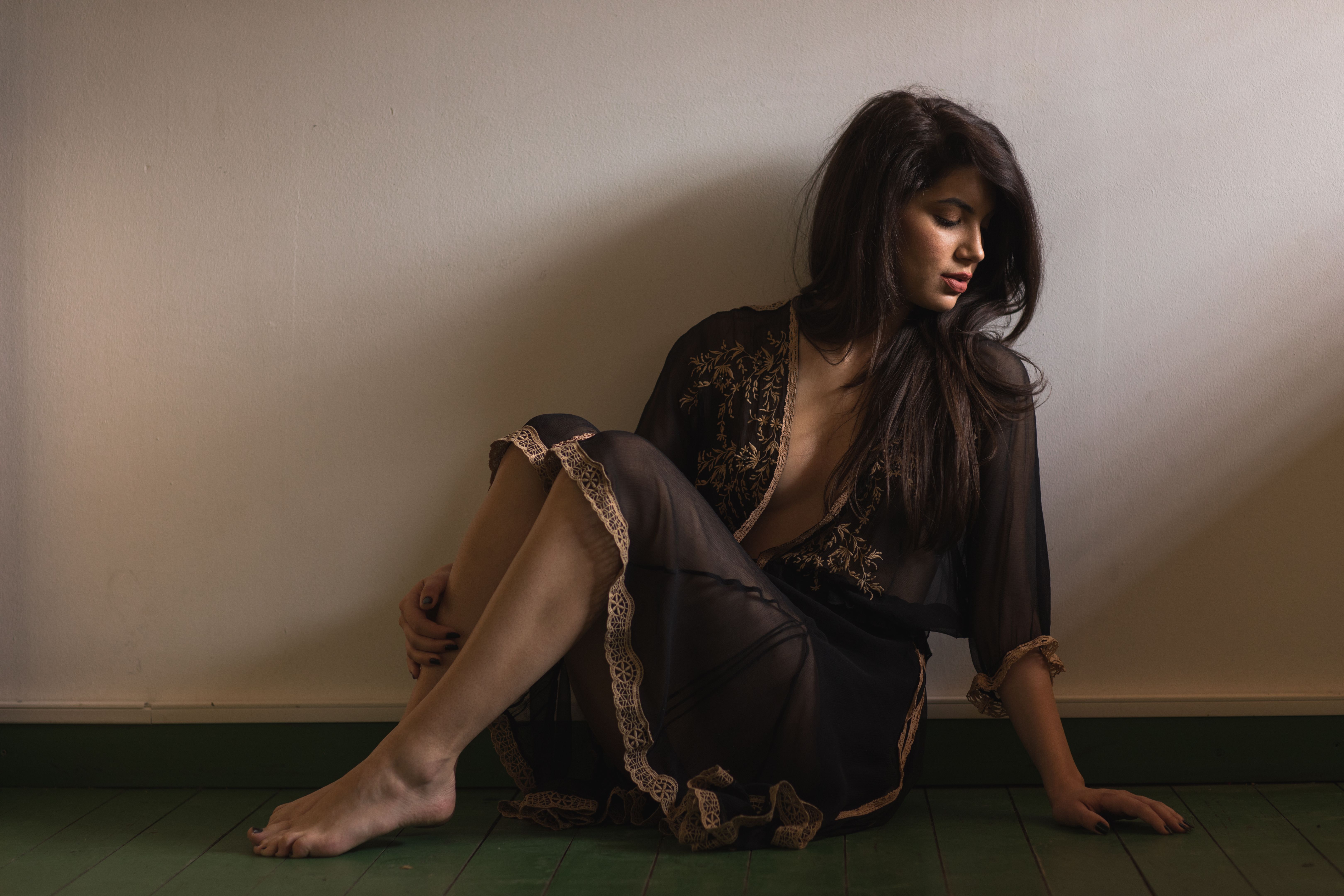 Beautiful young woman sitting  on floor