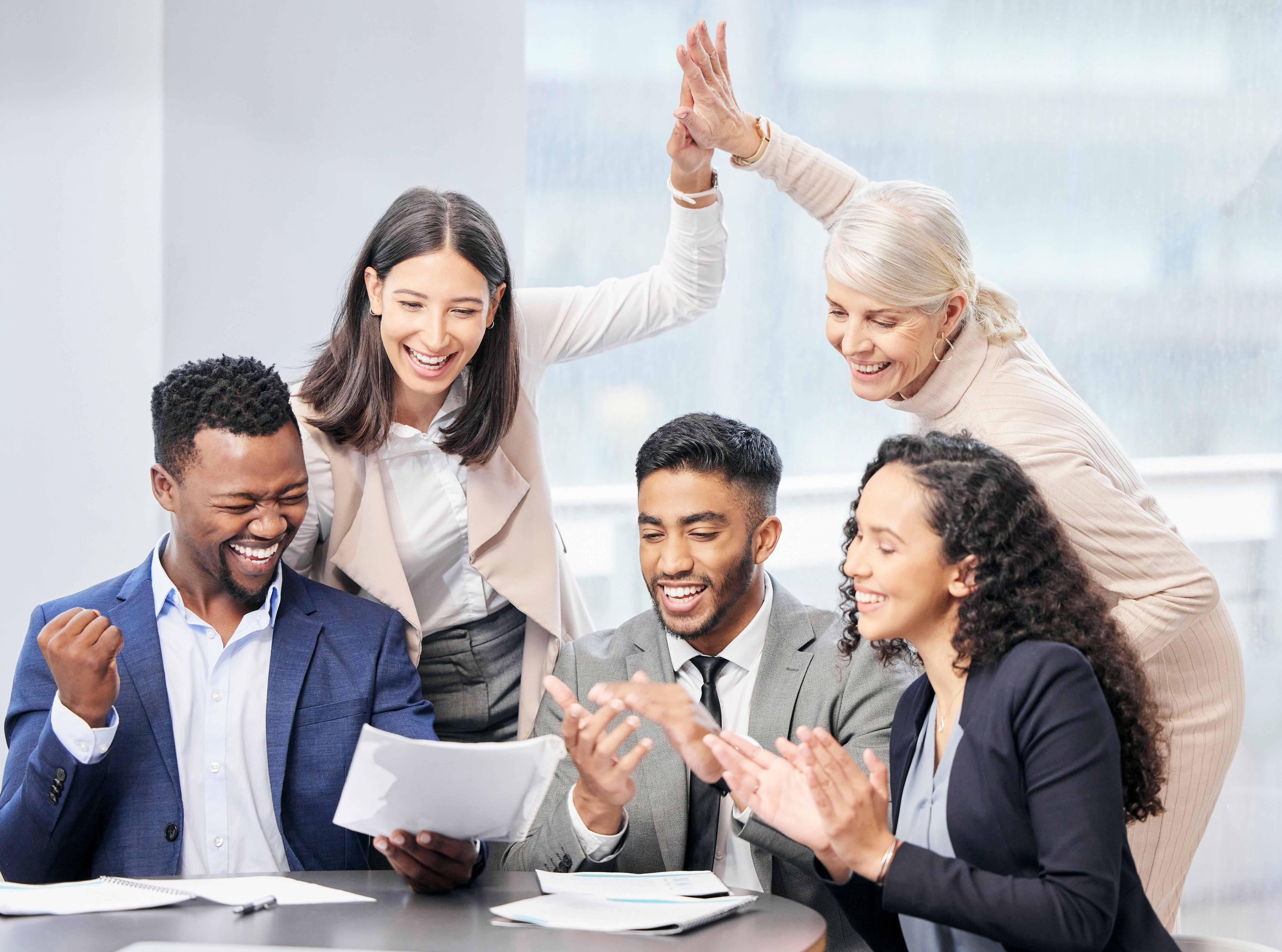 Shot of a team of business people reading through documents during a meeting Shot of a team of business people reading through documents during a meeting