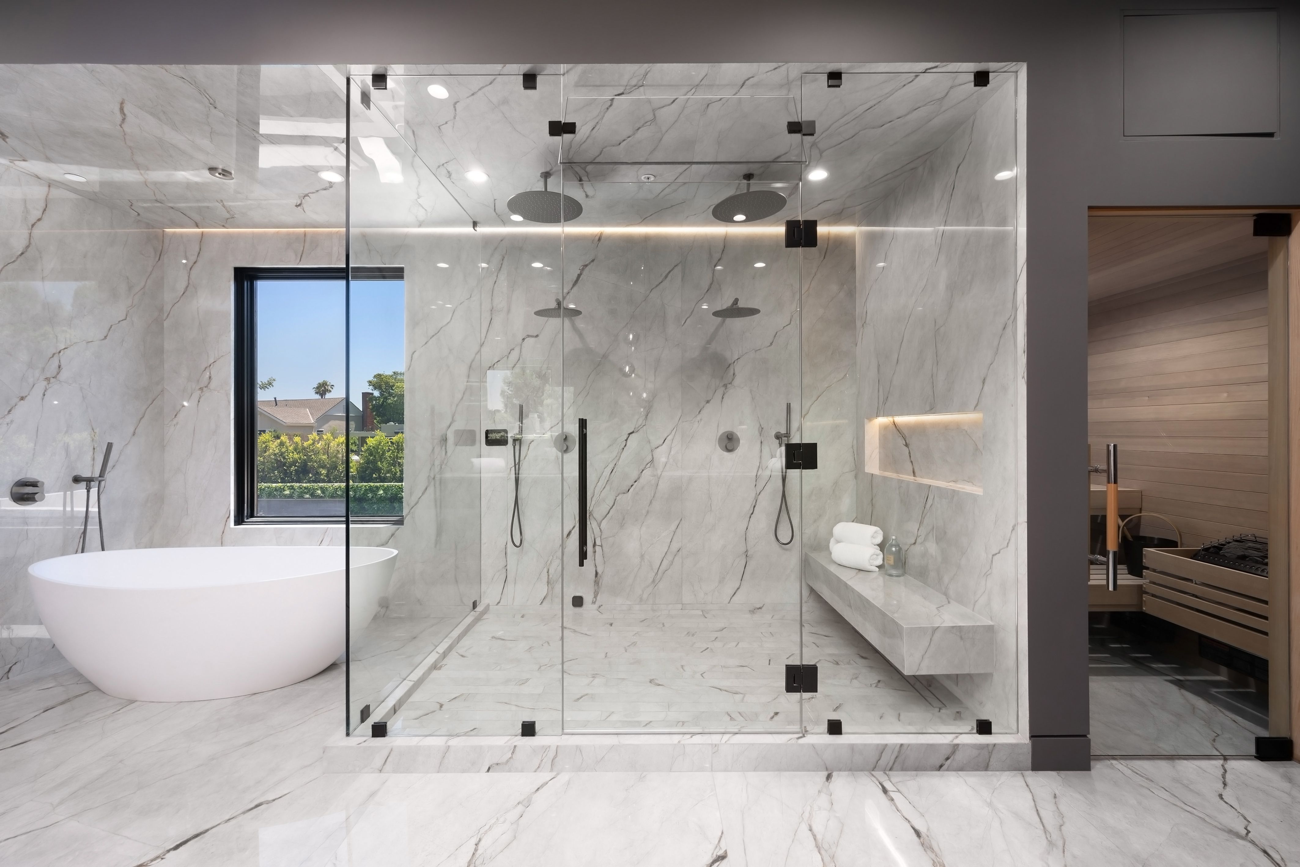 Modern luxury bathroom with glass shower and sauna