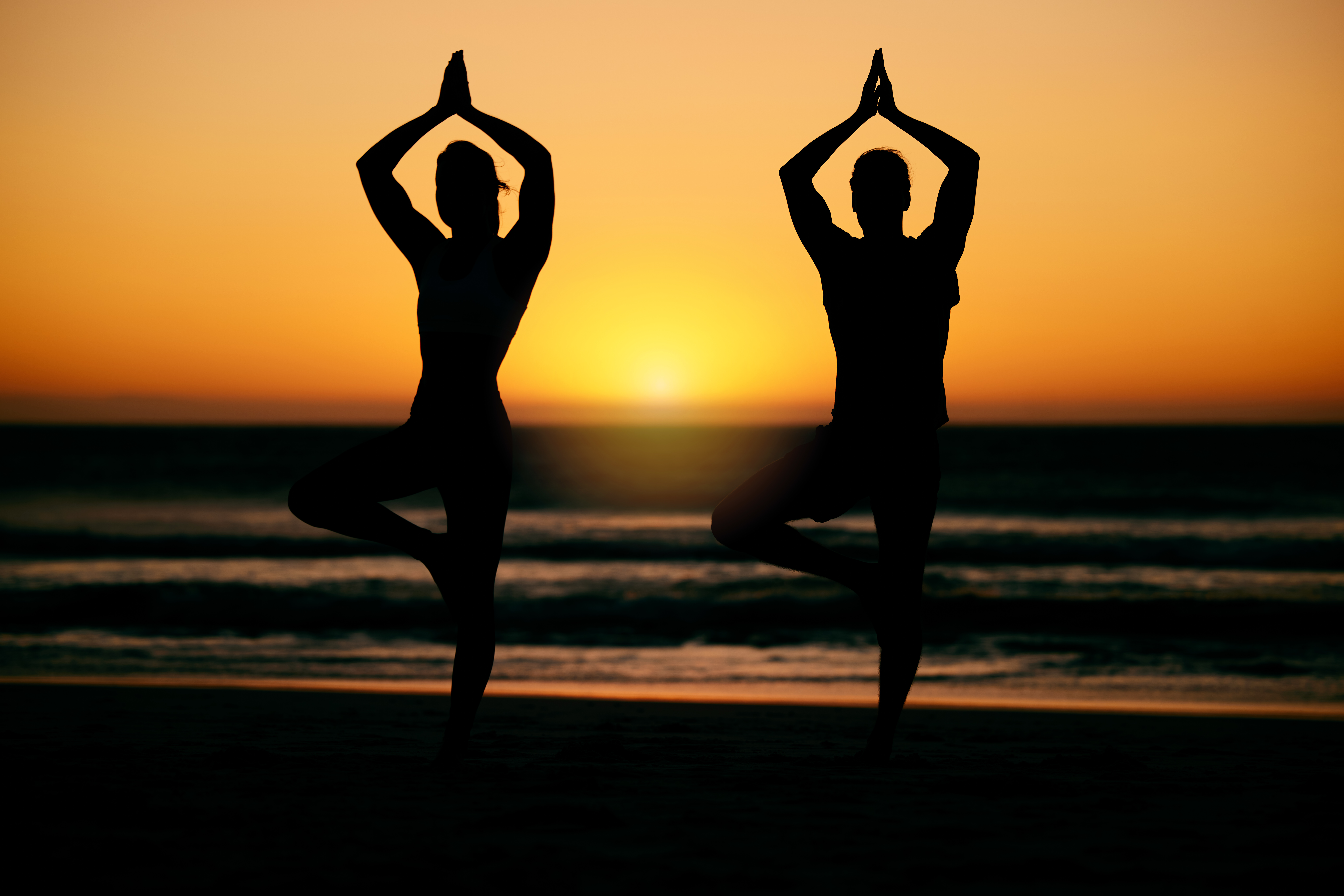 Prayer hands, yoga silhouette and meditation with couple at  beach for health or wellness. Sunset, pilates shadow and man and woman with namaste hand pose for training, zen chakra or balance exercise