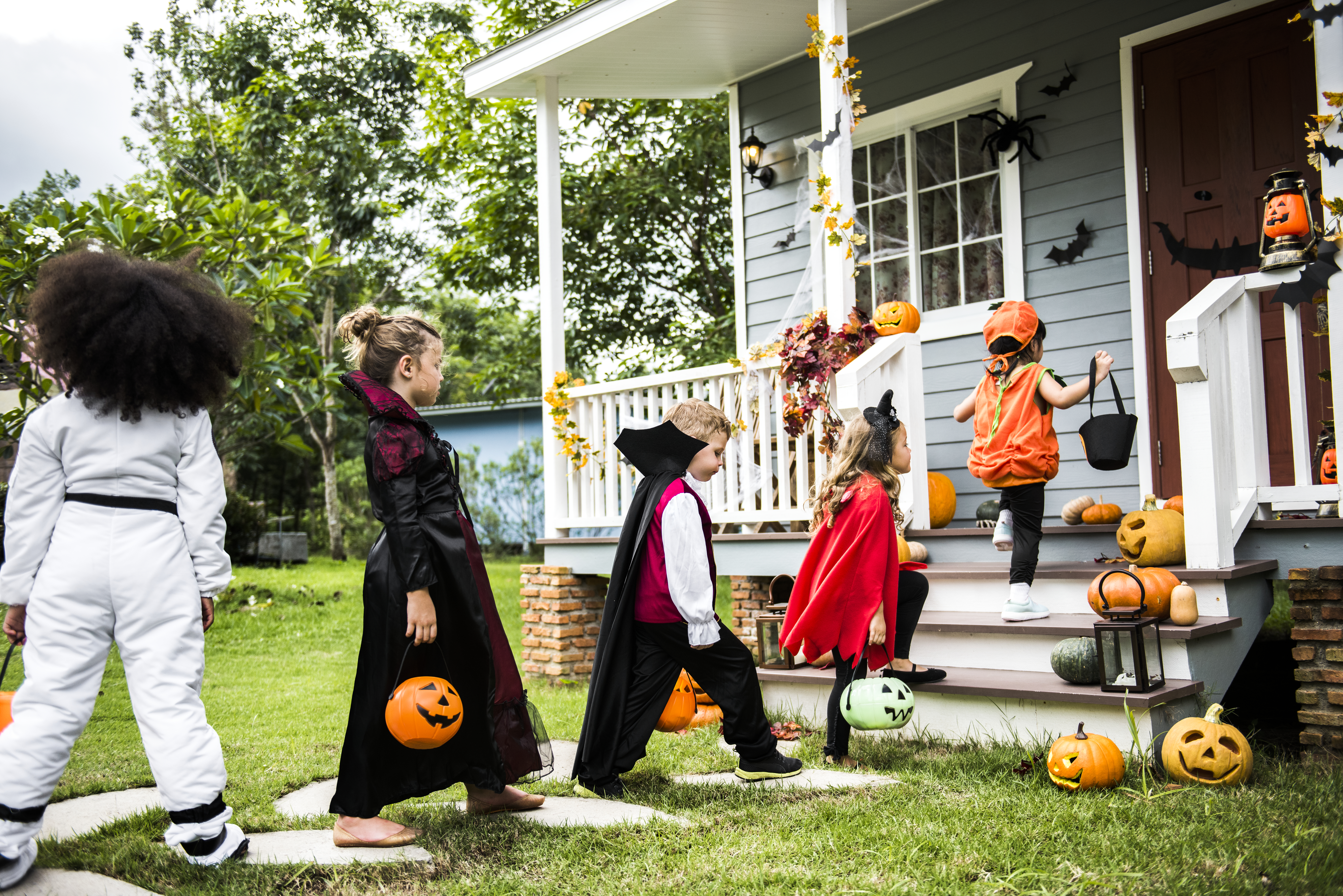 Little children in costumes trick or treating Little children in costumes trick or treating