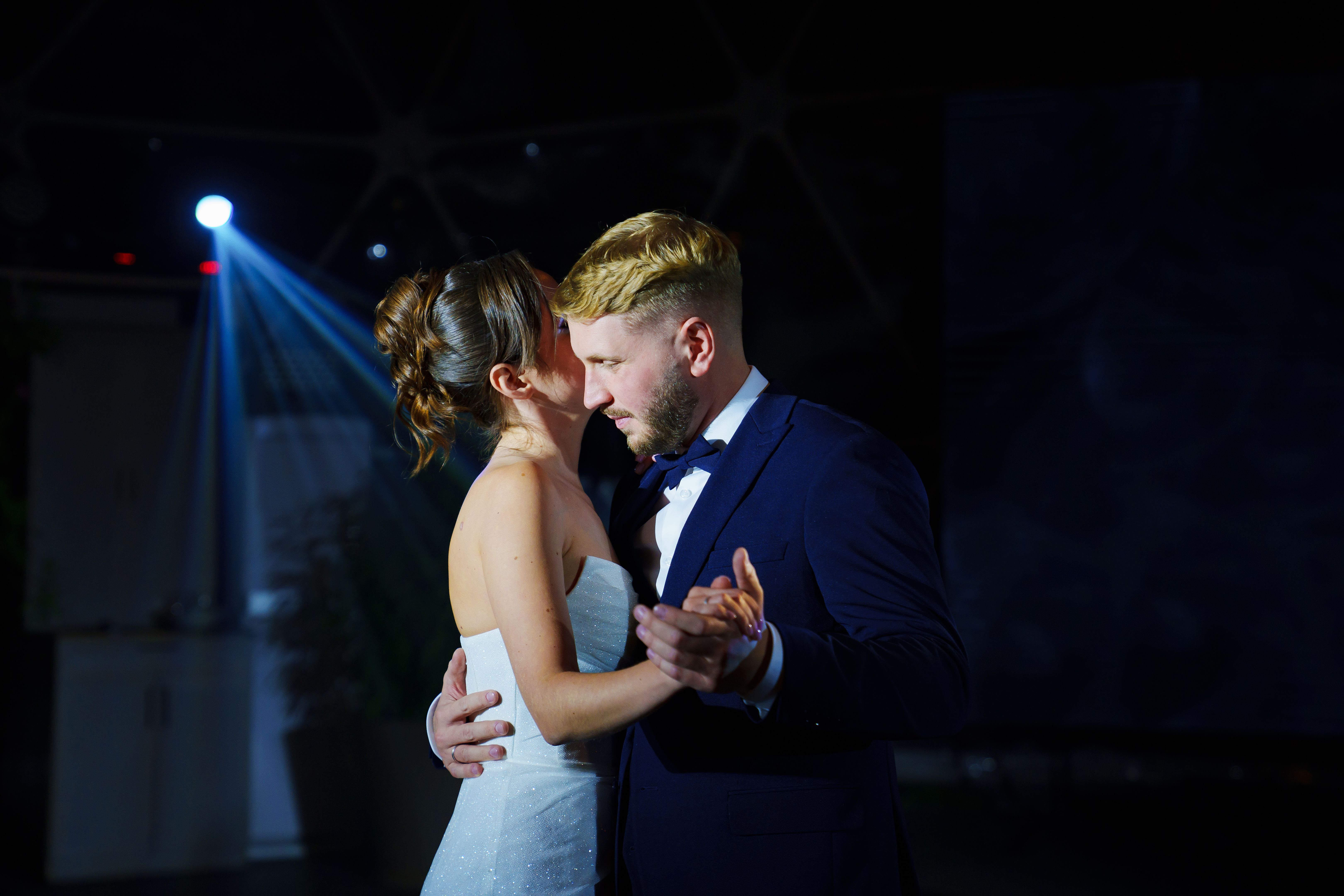 The bride and groom dance the first dance at the wedding banquet.