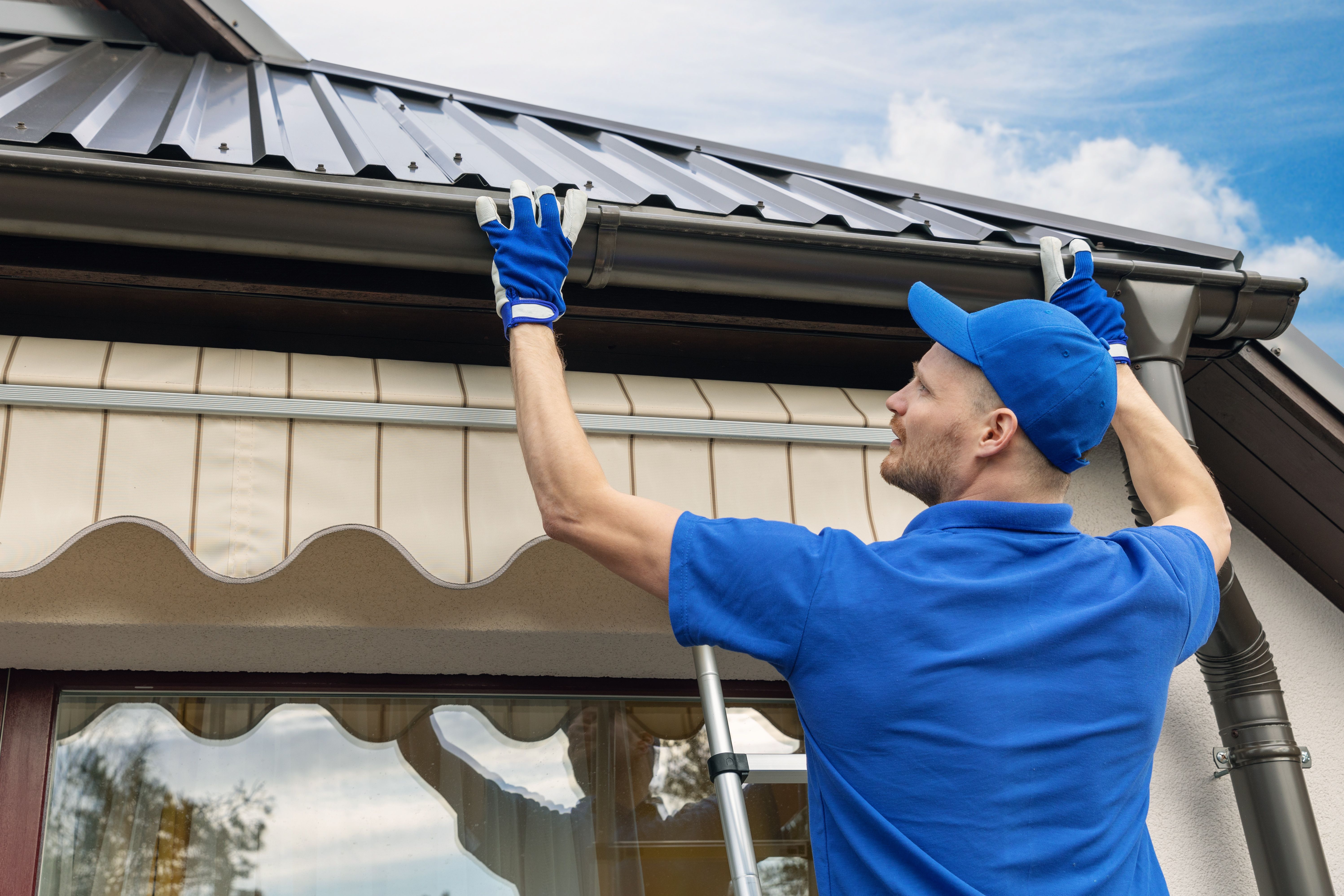 contractor installing gutters