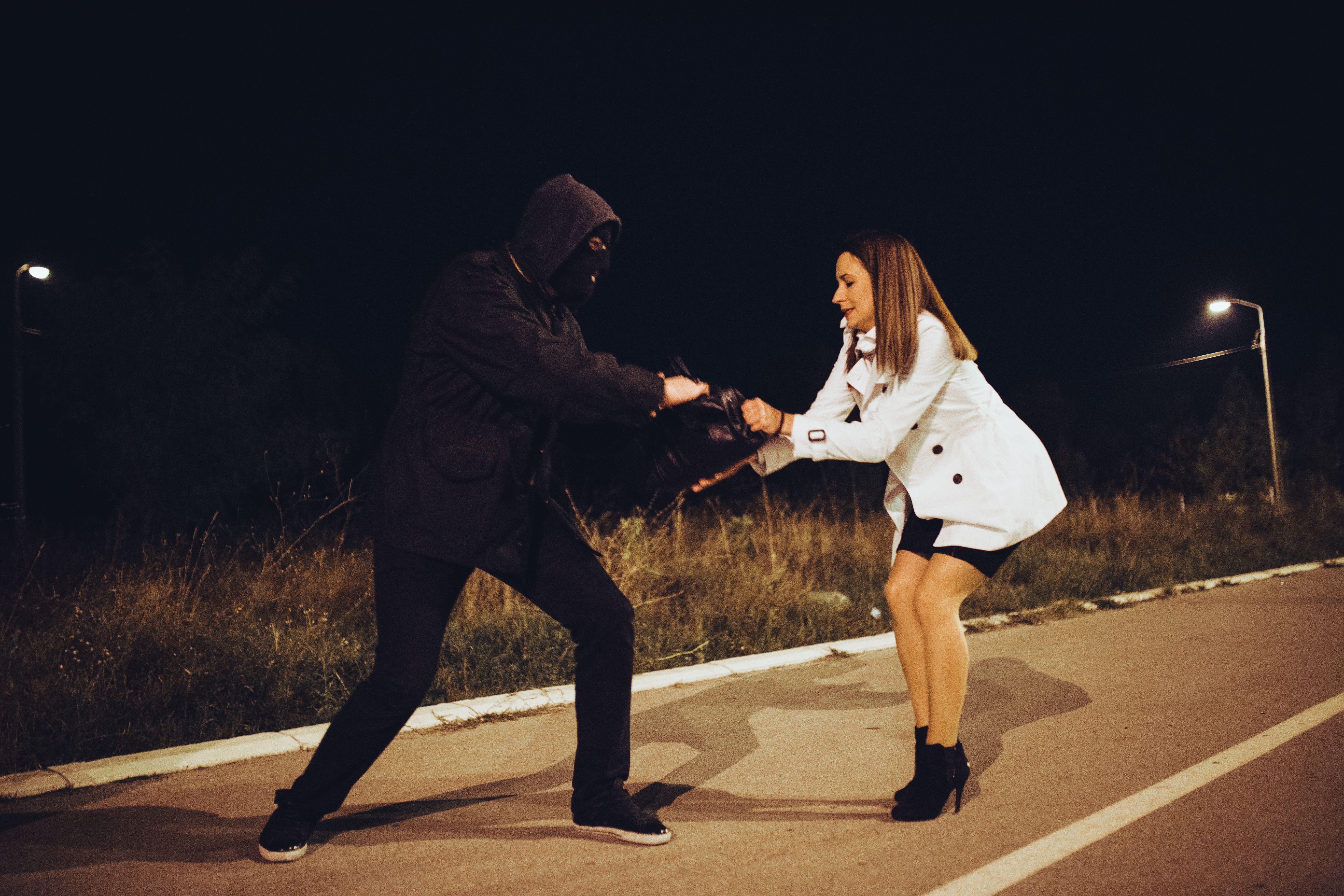 Robber stealing businesswoman bag