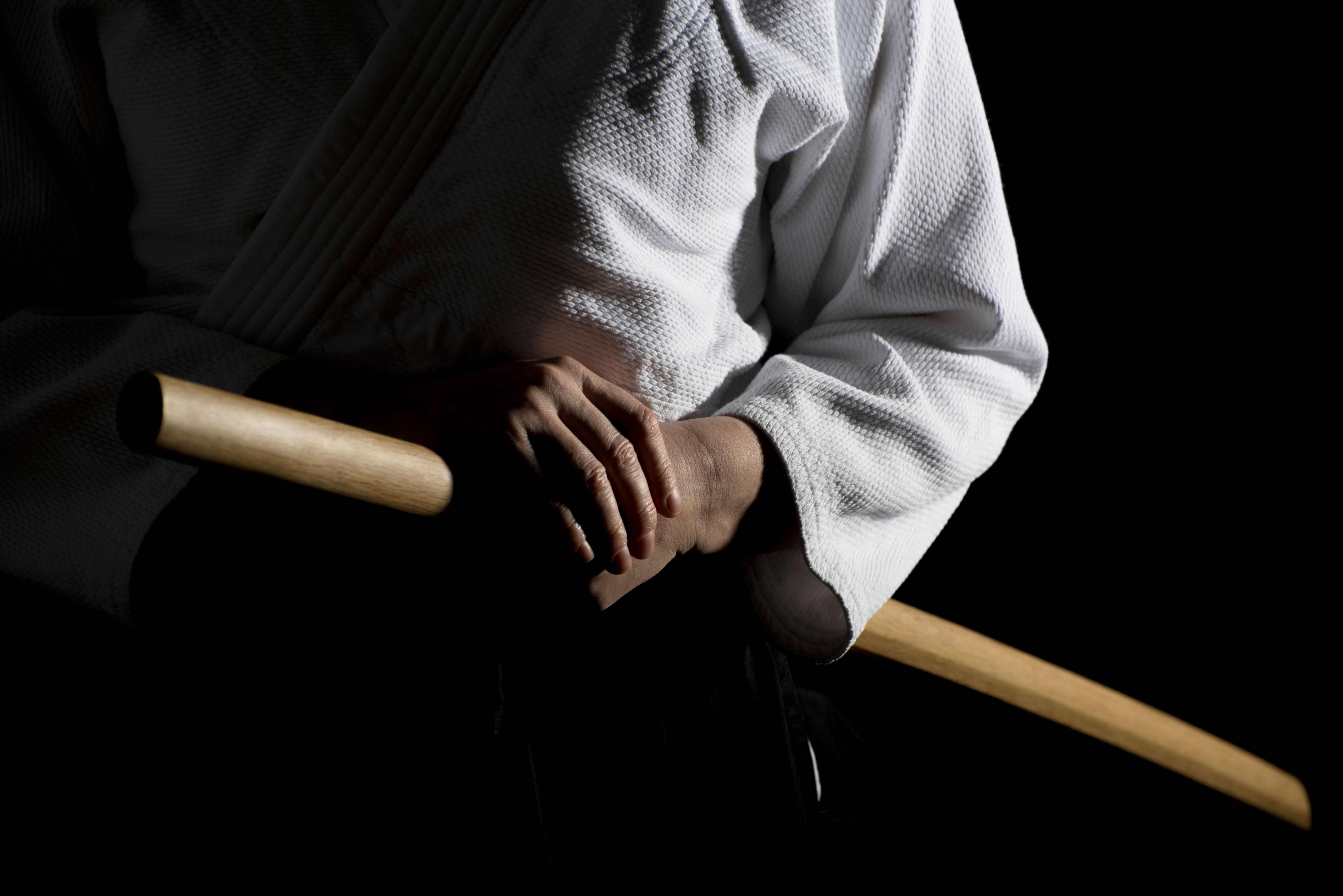 Fighting Pose with Bokken Over Black