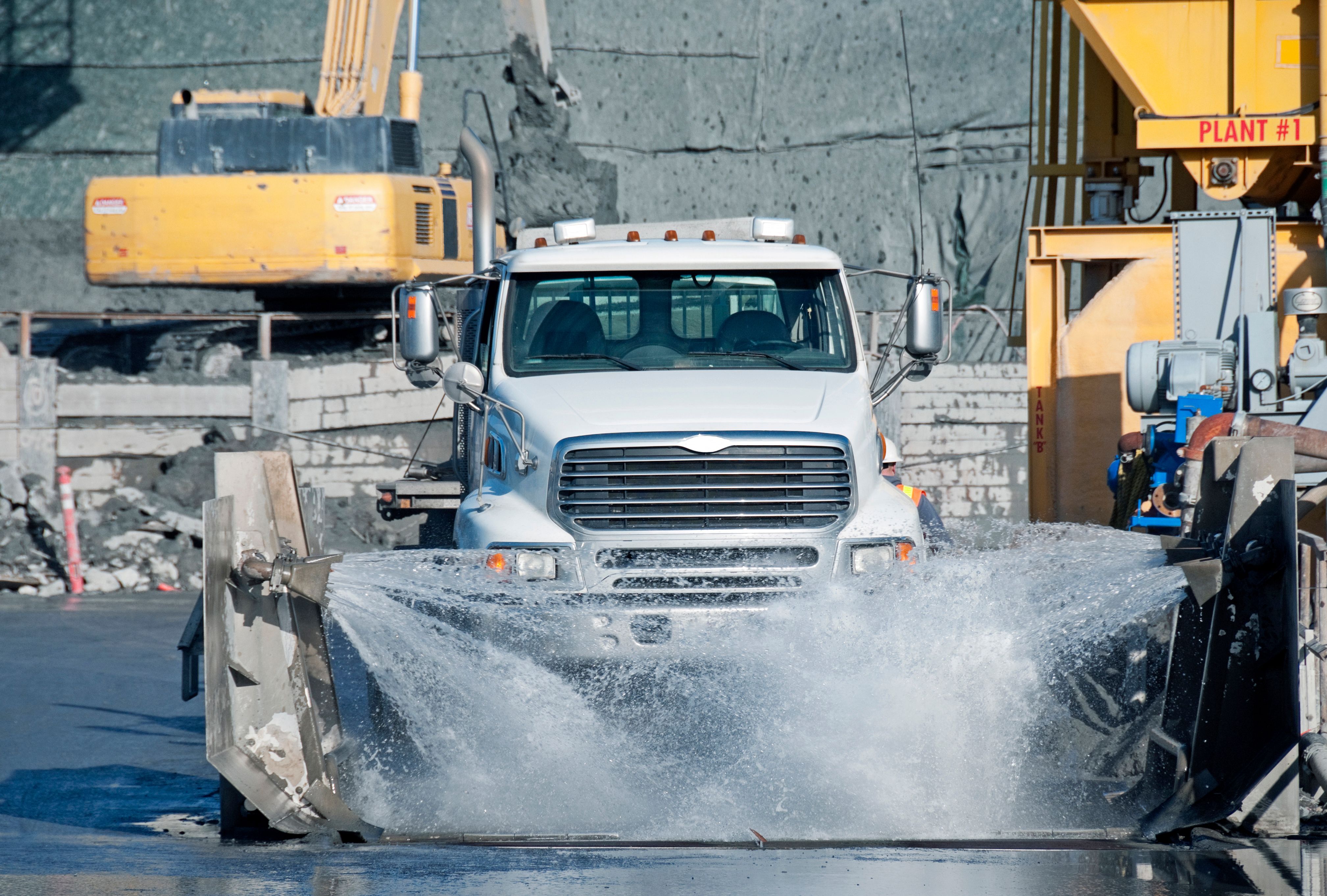 Truck having tires washed at construction site Truck having tires washed at construction site