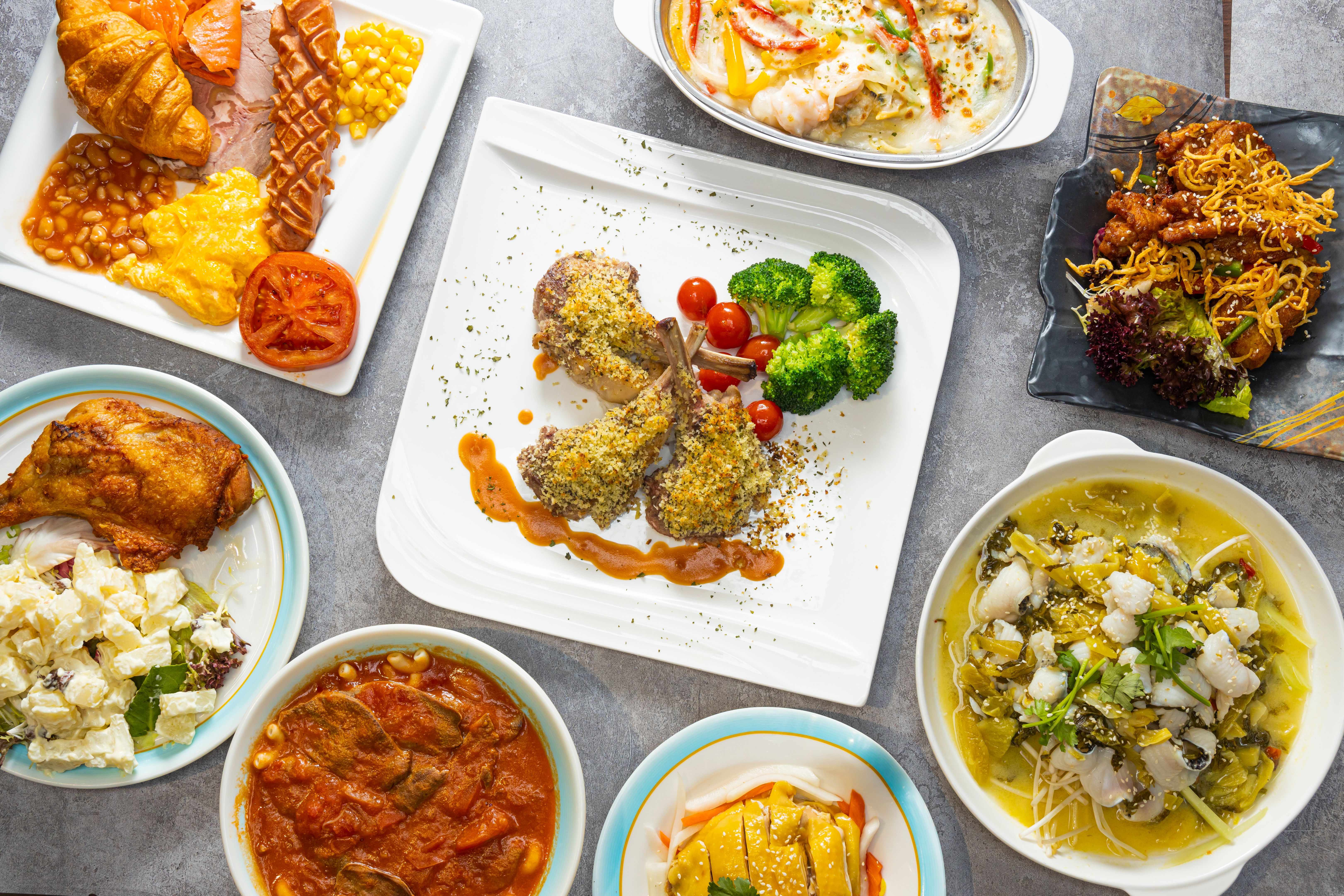 Top view of a set of different dishes like lamb and fish and breakfast on a table in a restaurant Top view of a set of different dishes like lamb and fish and breakfast on a table in a restaurant