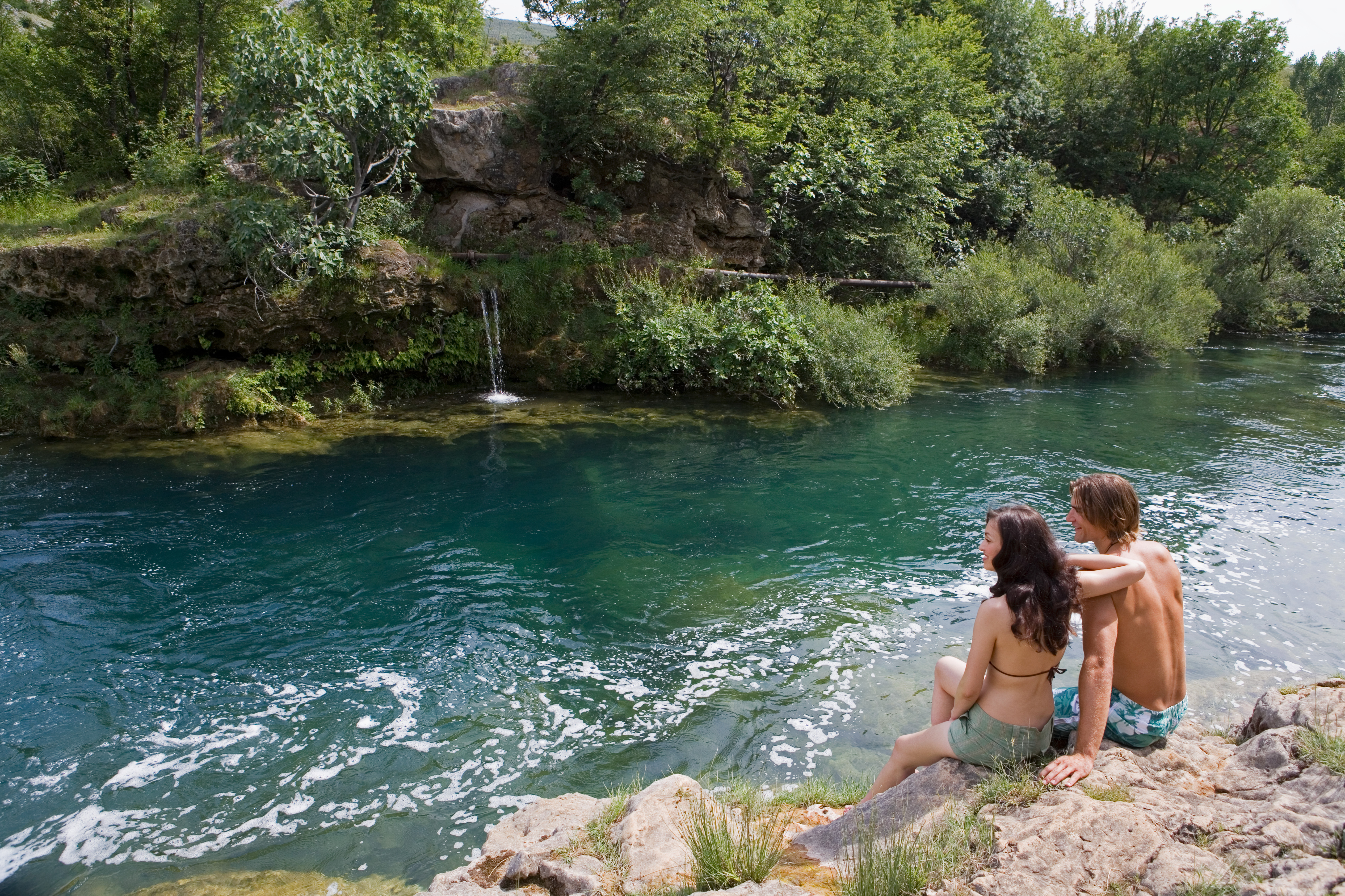 Couple resting near a stream