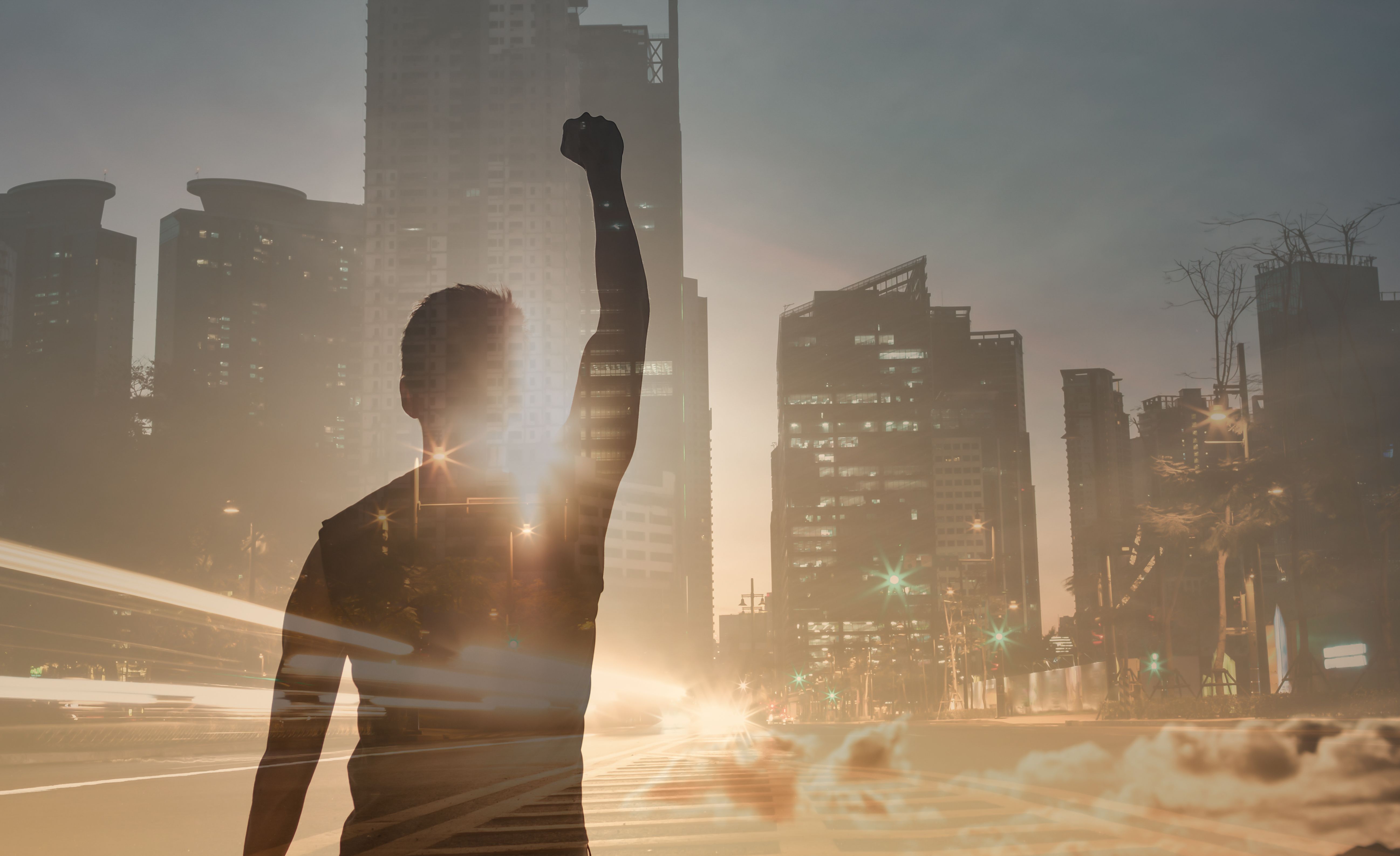 Strong young man in the city feeling powerful, determined and having courage to overcome challenges.