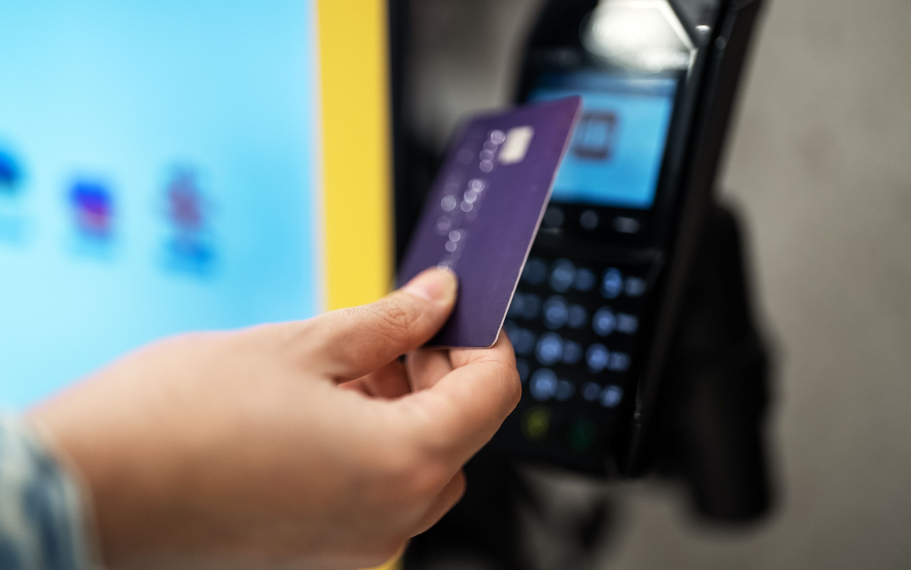 Woman pays with card at a self-service payment terminal. Woman pays with card at a self-service payment terminal.