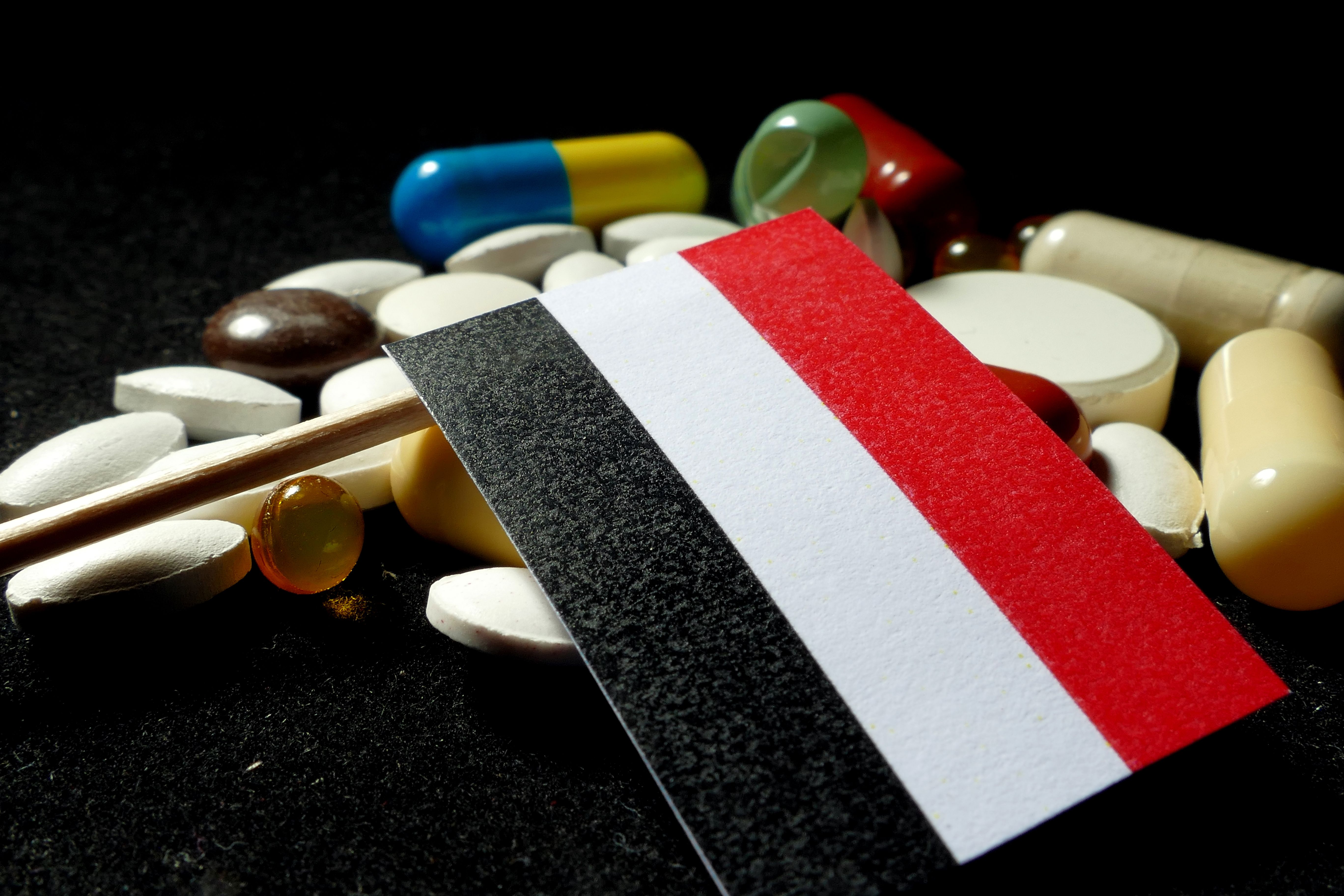 Yemeni flag with lot of medical pills isolated