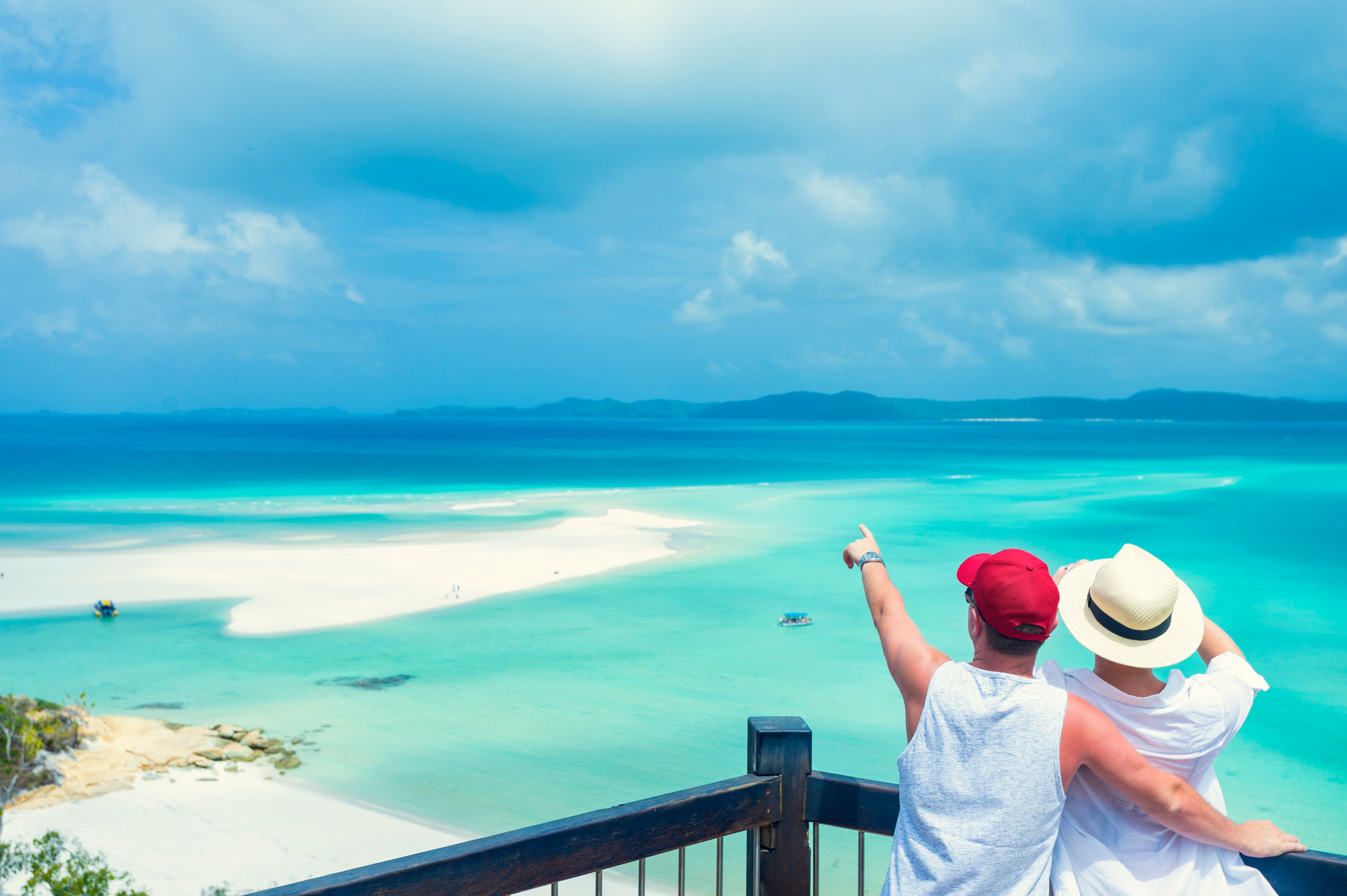Couple looking at the view of Whitehaven beach. Couple looking at the view of Whitehaven beach.
