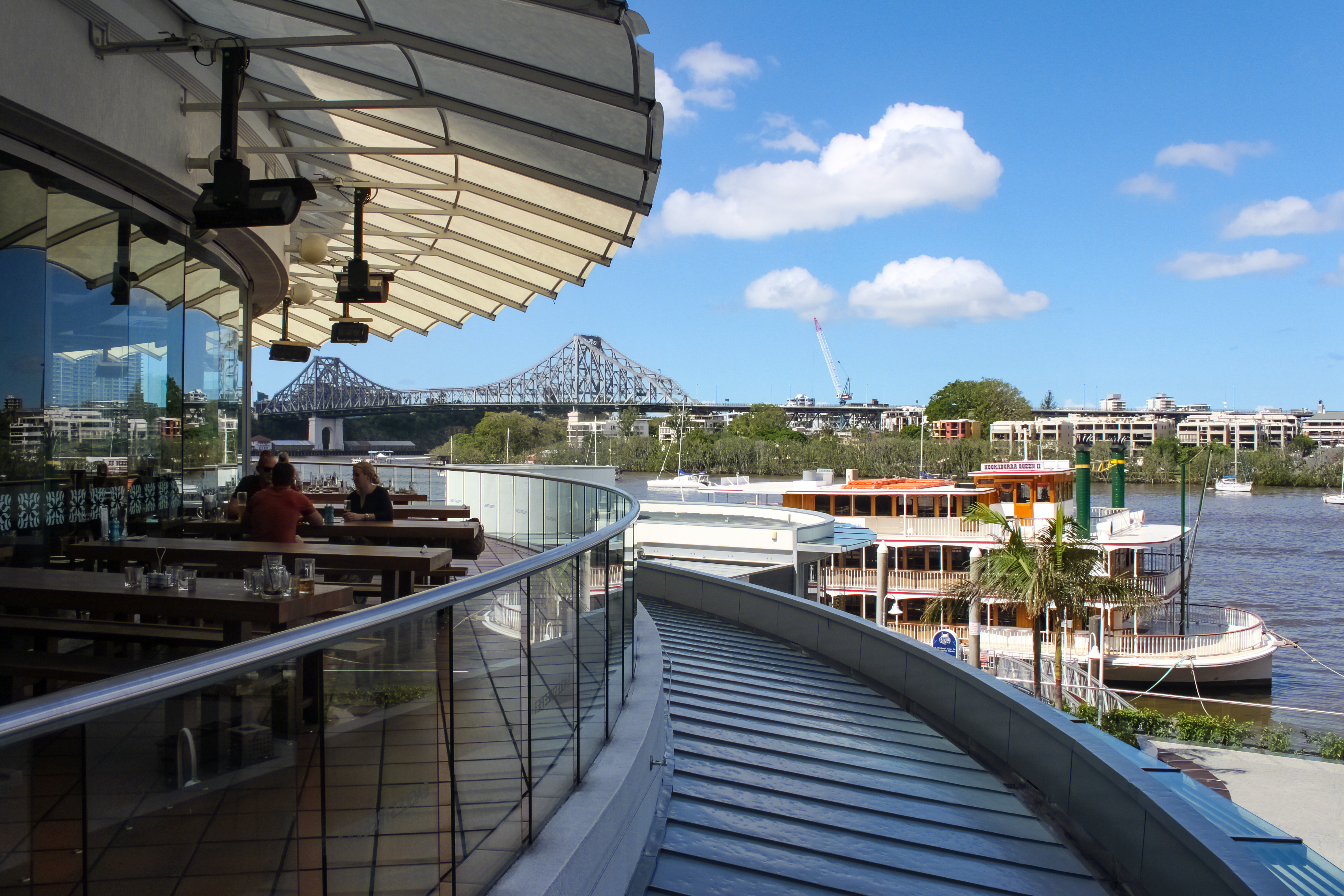 View of Story Bridge and Kookaburra Queen steamboat from deck of Eagle Pier resturants