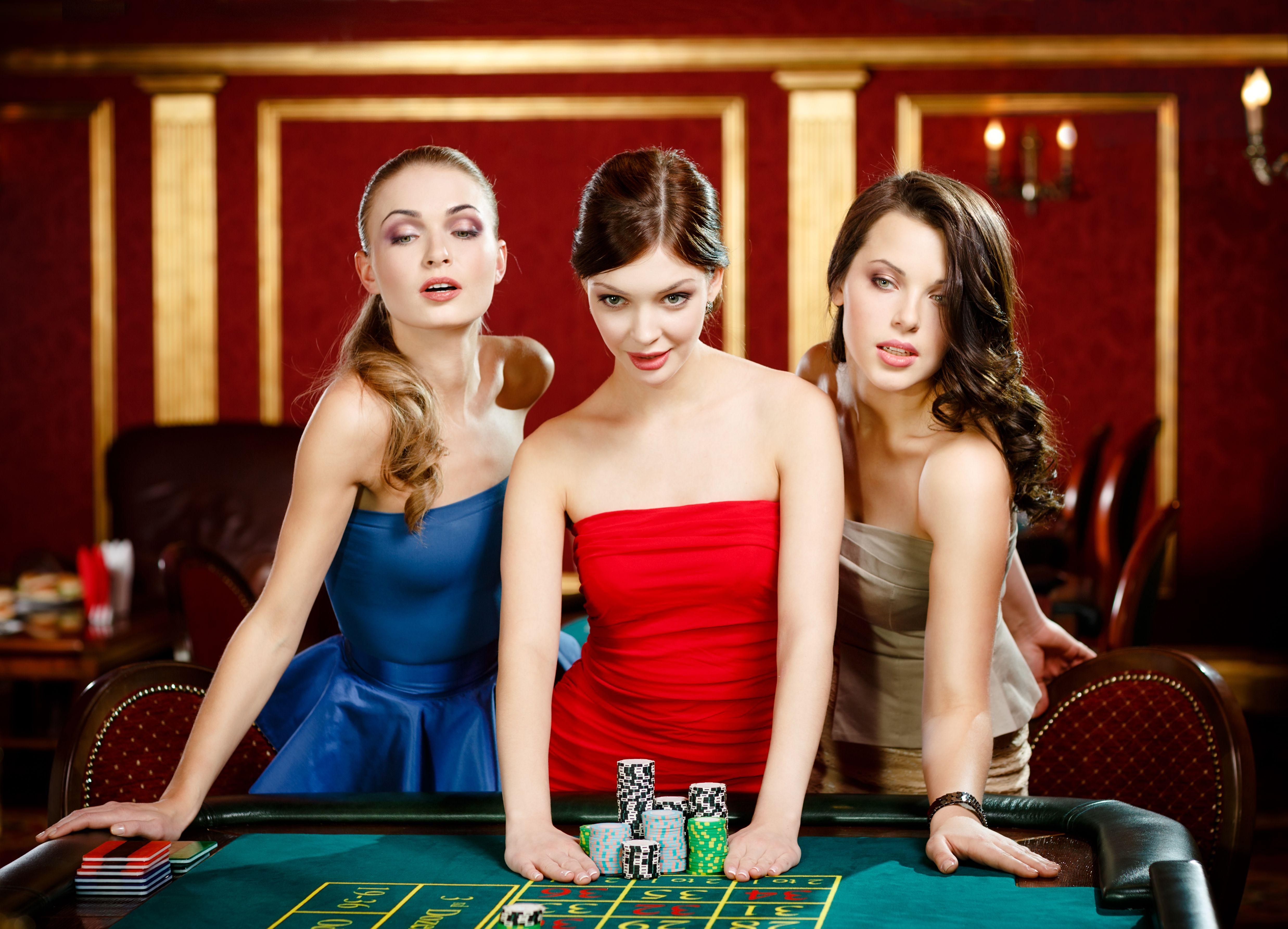 Three ladies place a bet playing roulette