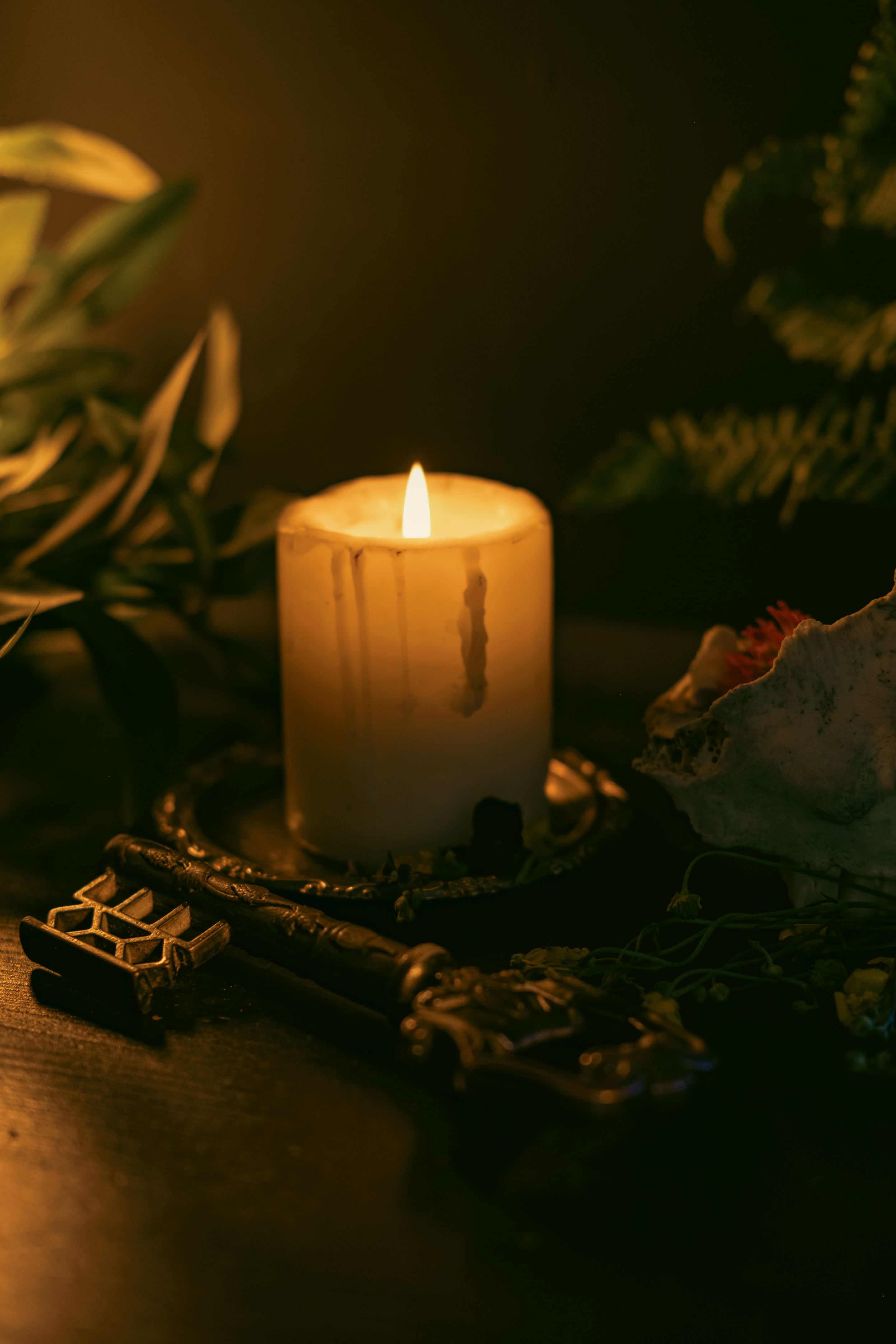 Magical ritual with a candle and an old key.