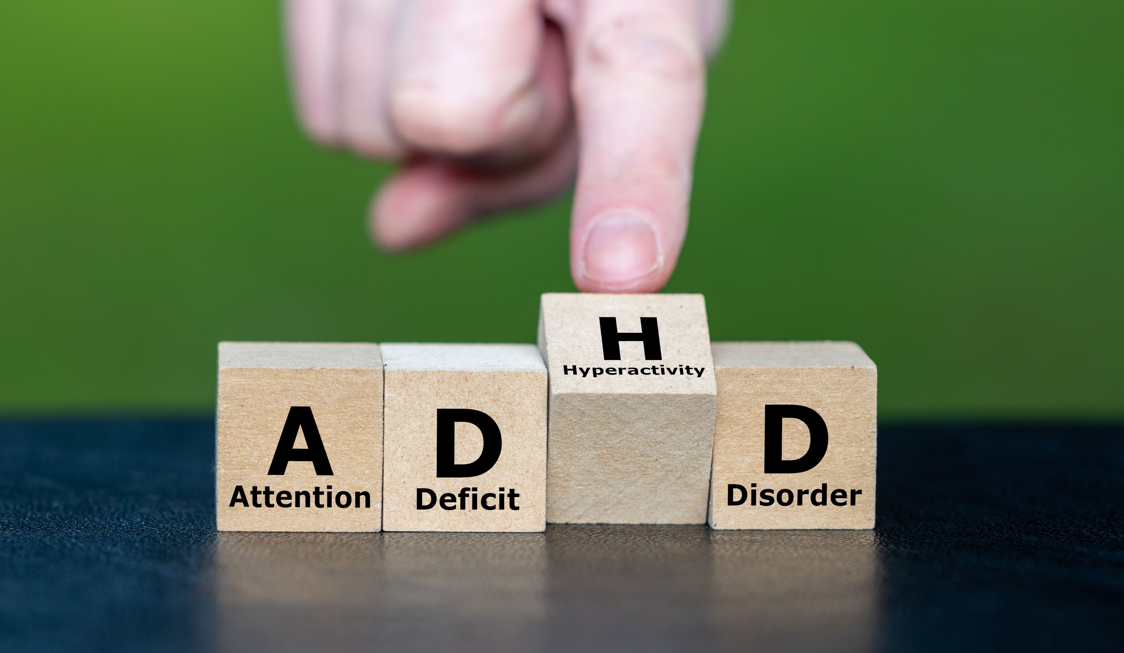 Hand turns cube and changes the acronym ADD (Attention Deficit Disorder) to ADHD (Attention Deficit Hyperactivity Disorder)