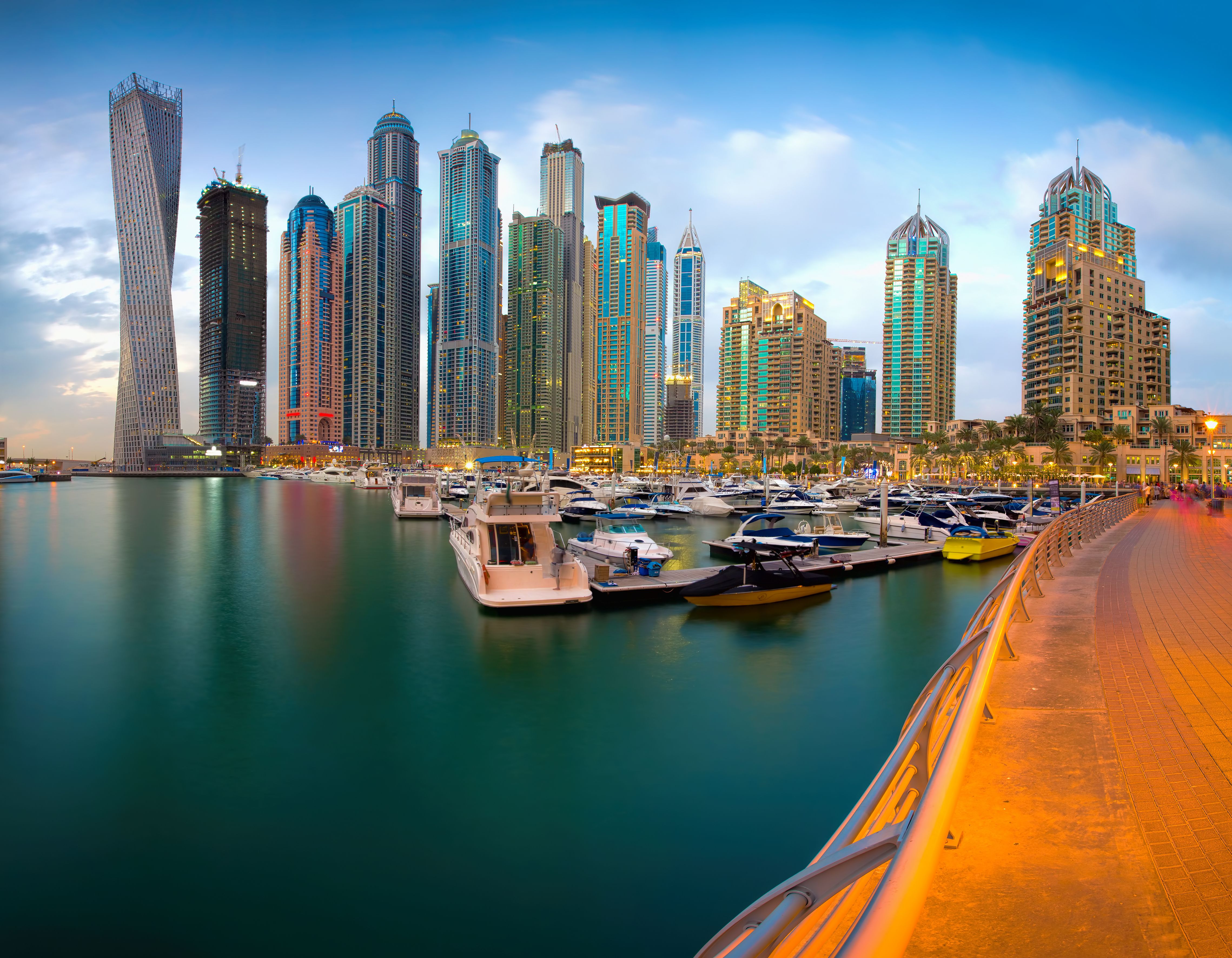 View of Dubai Skyline from marina with blue sky and water